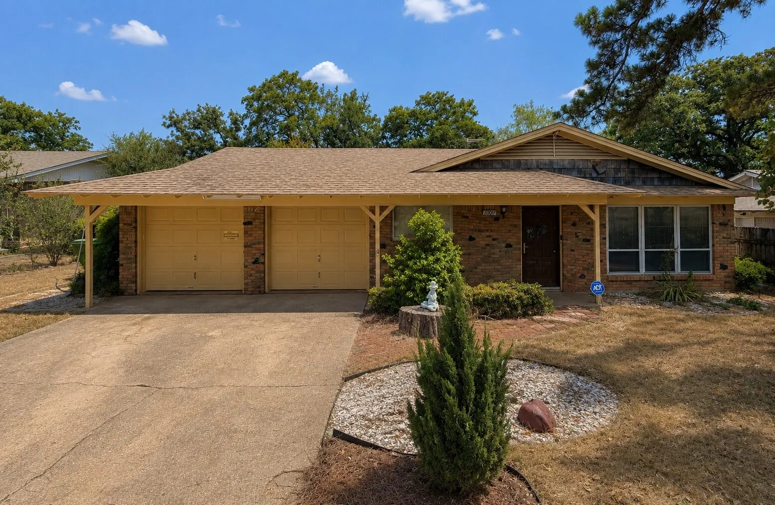 Brick exterior with a covered entryway and a wood-slatted gable