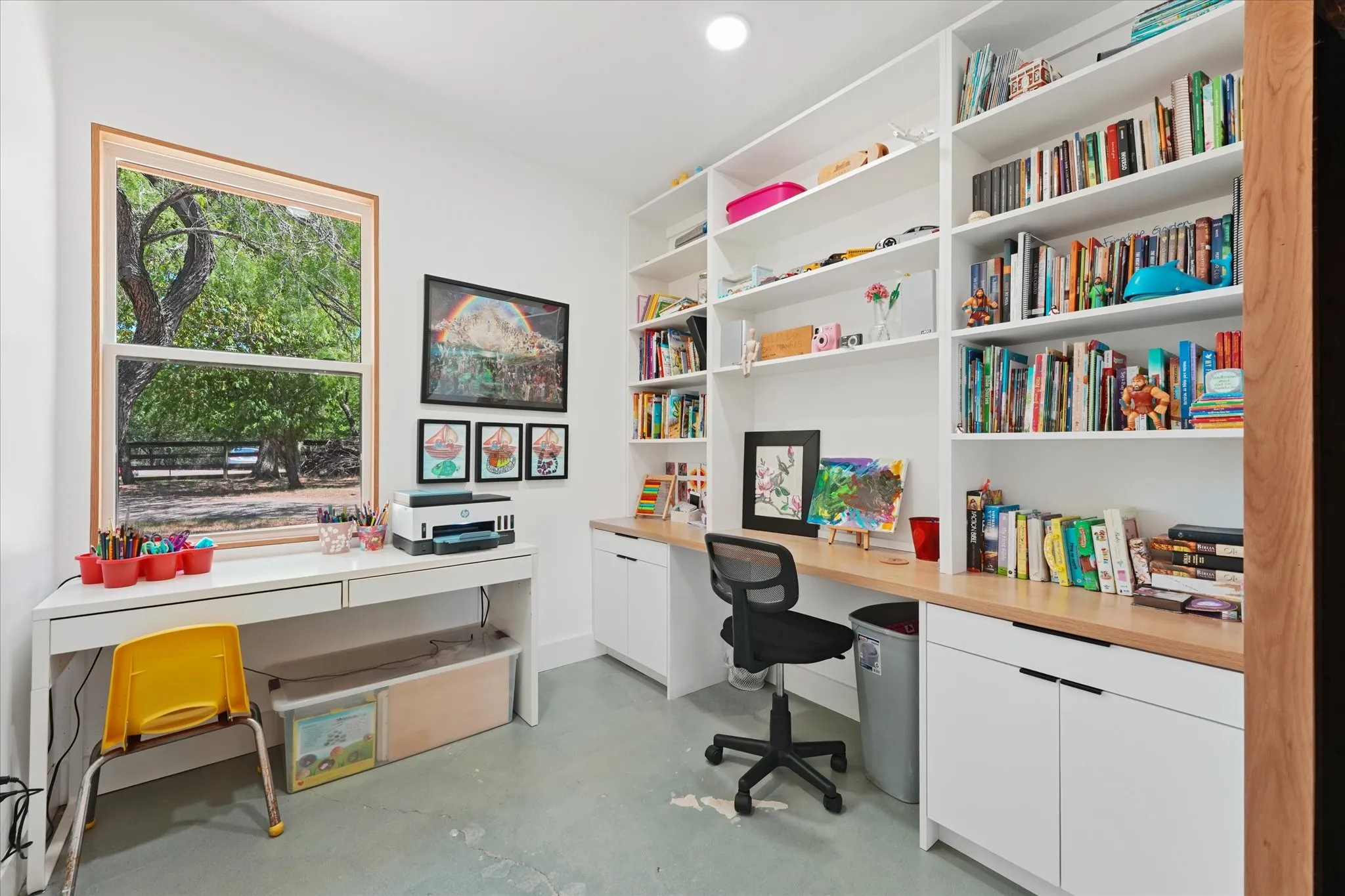 Built-in shelving, expansive built-in desk, wood-finish countertops, and recessed lighting