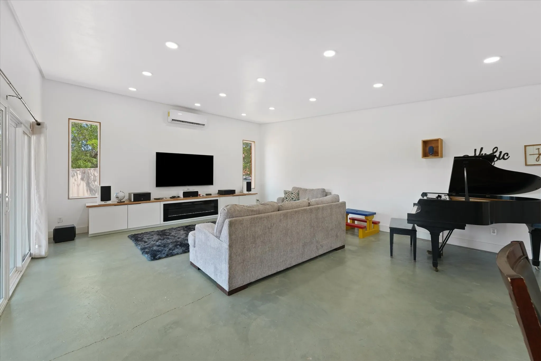 Spacious room with recessed lighting, light-toned flooring, and white walls