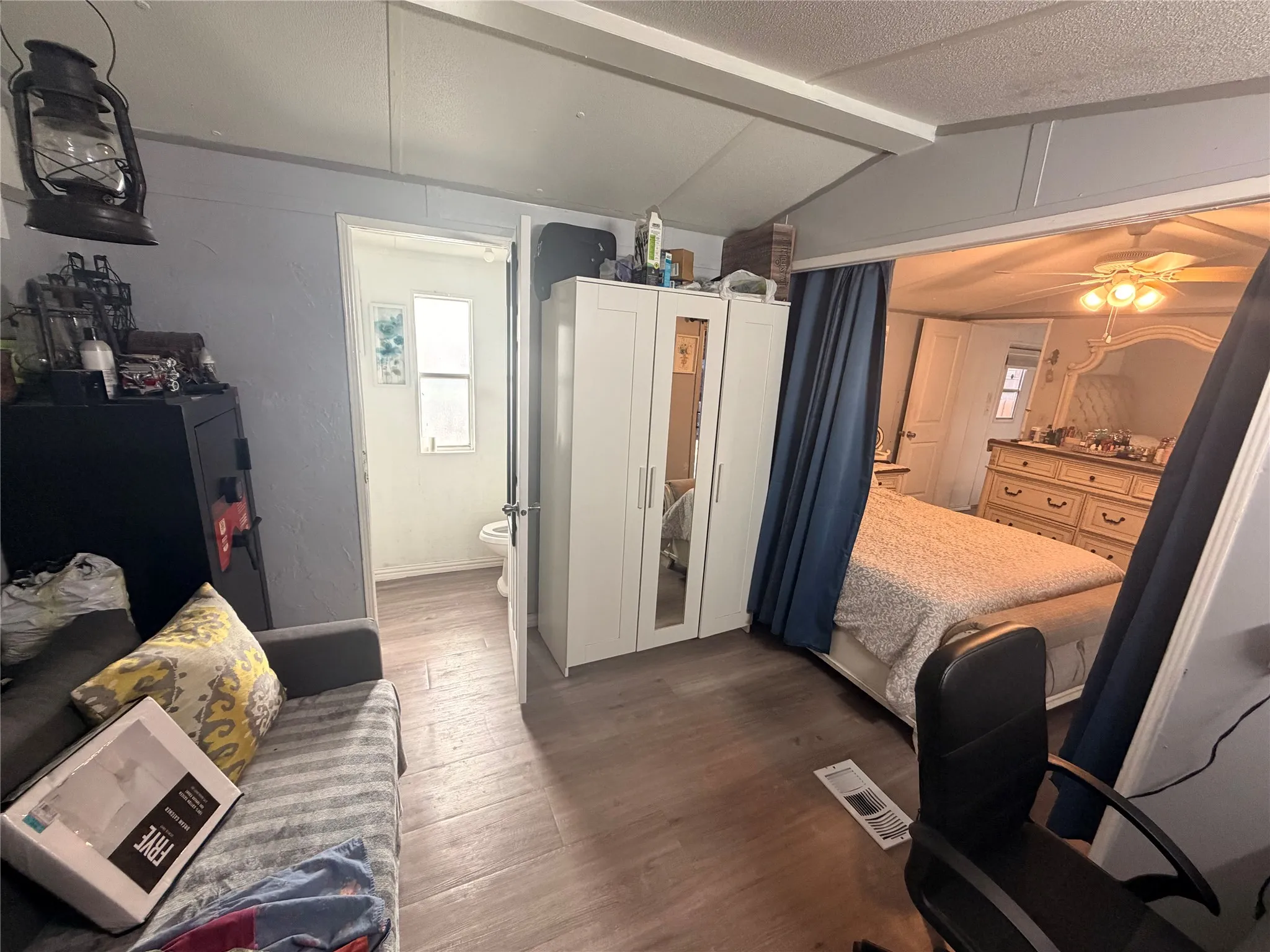 master bedroom with half bathroom and office