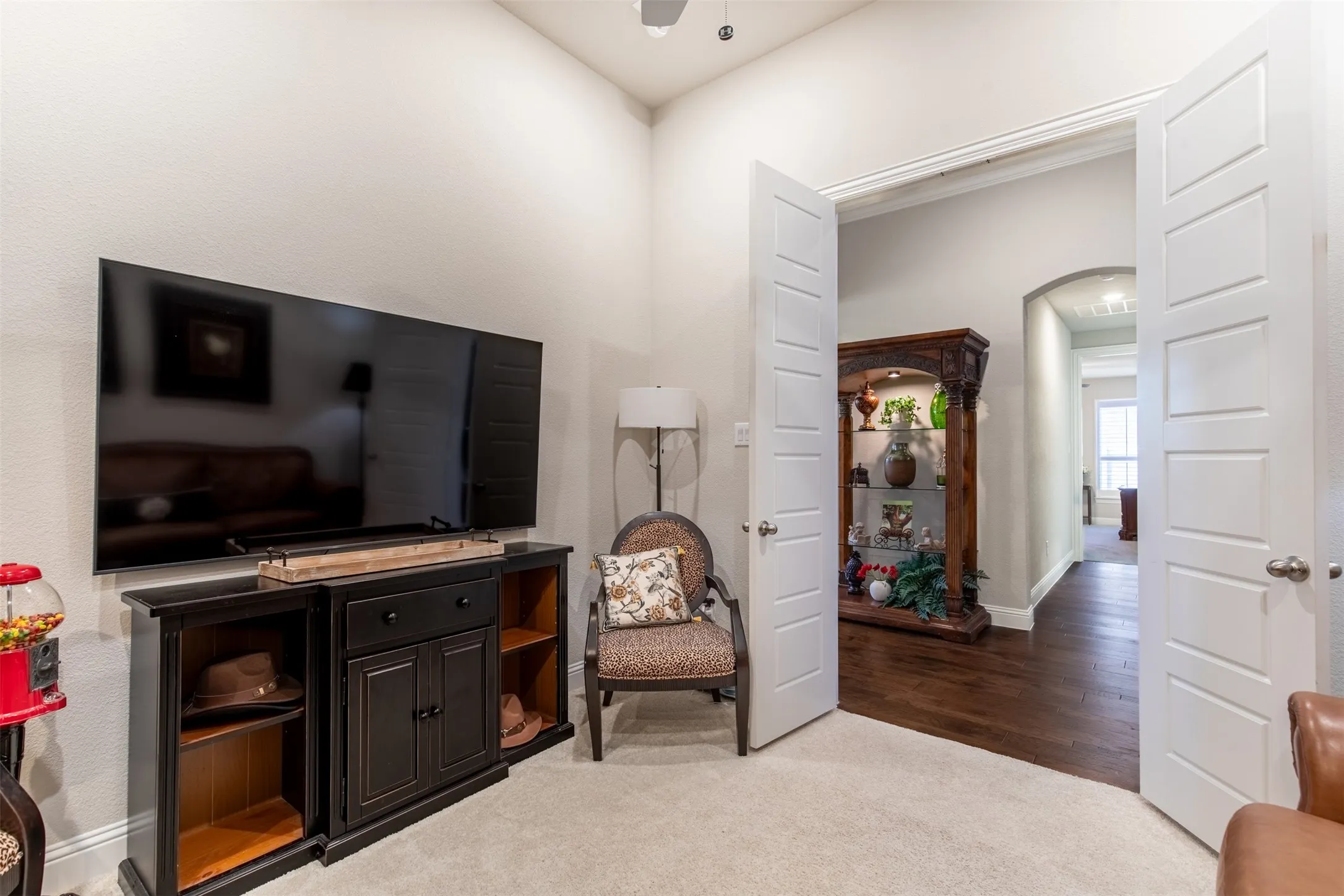 The solid wood french doors adds privacy to this space. The second hallway leads to the second primary bedroom.
