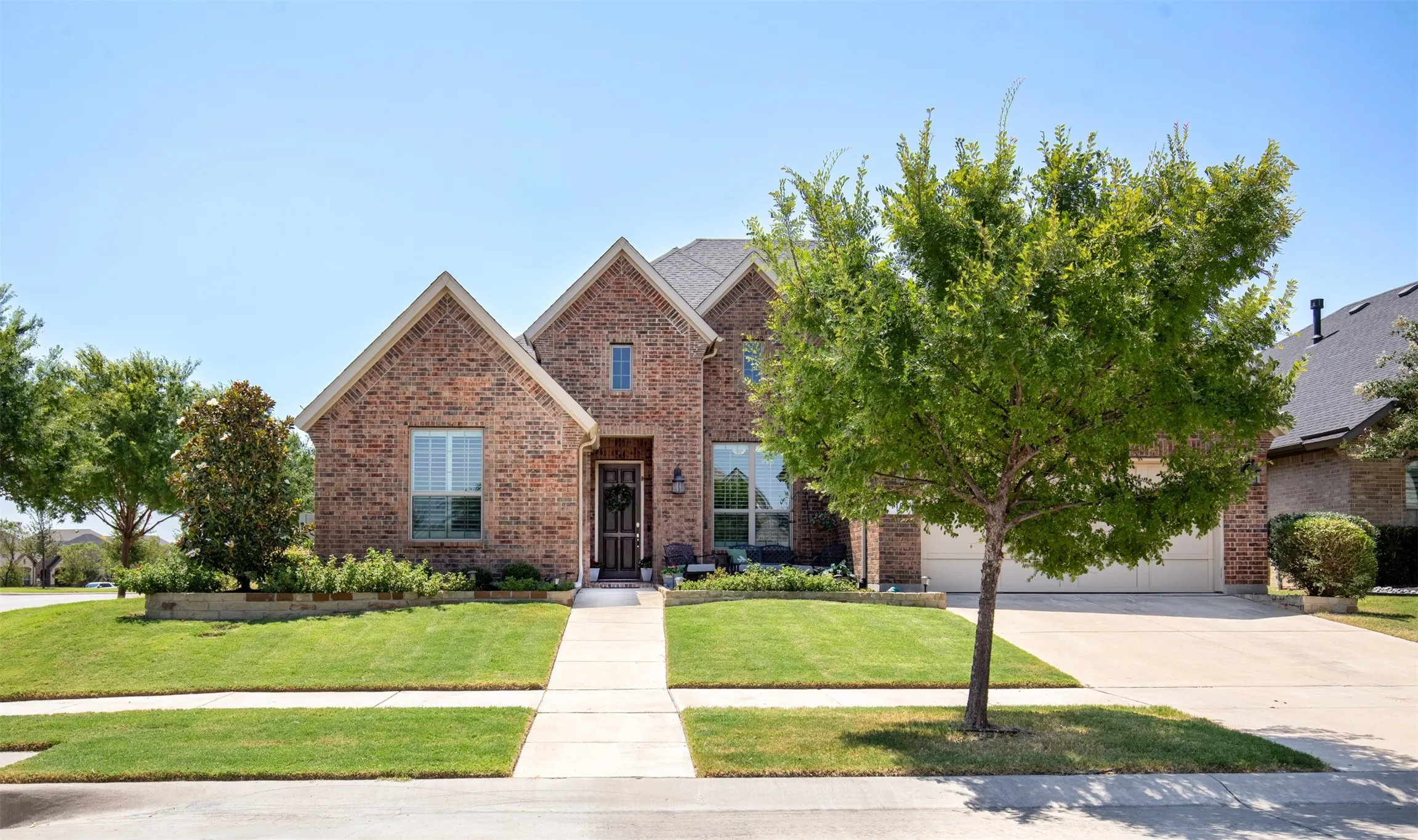 Beautifully situated on a corner lot, this home welcomes you with lush, mature landscaping, a manicured lawn, and standout curb appeal.