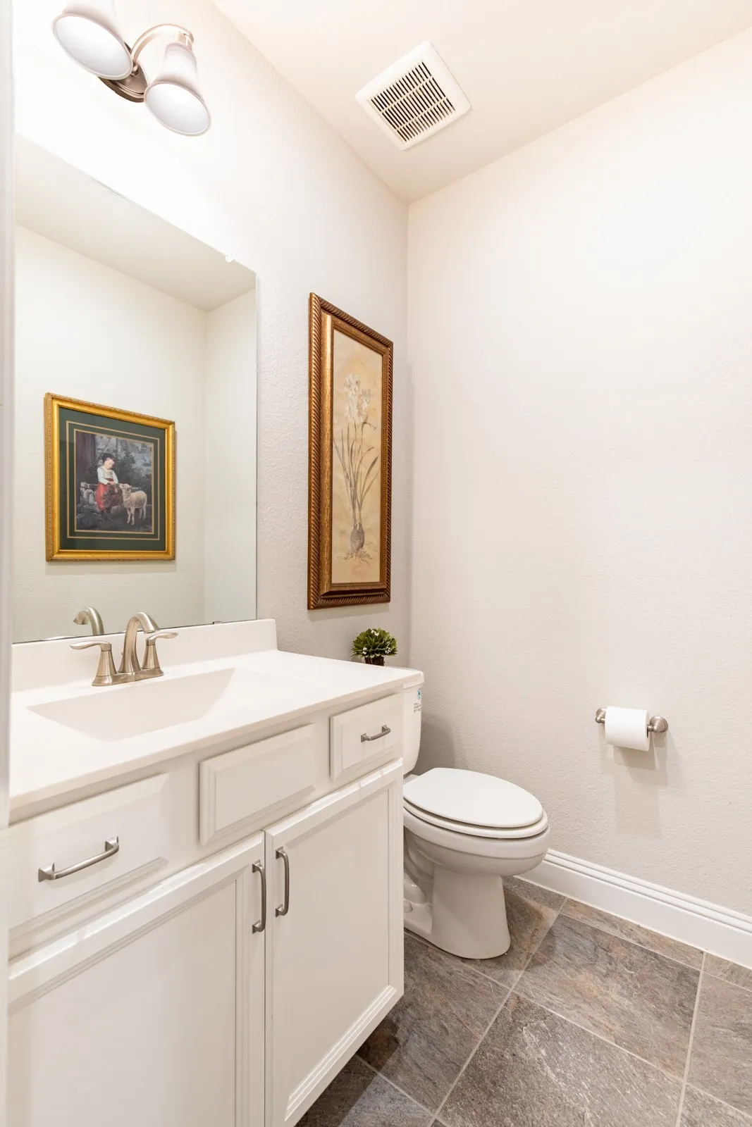Half bathroom is perfectly located off of the hallway by the utility room, garage door and office.