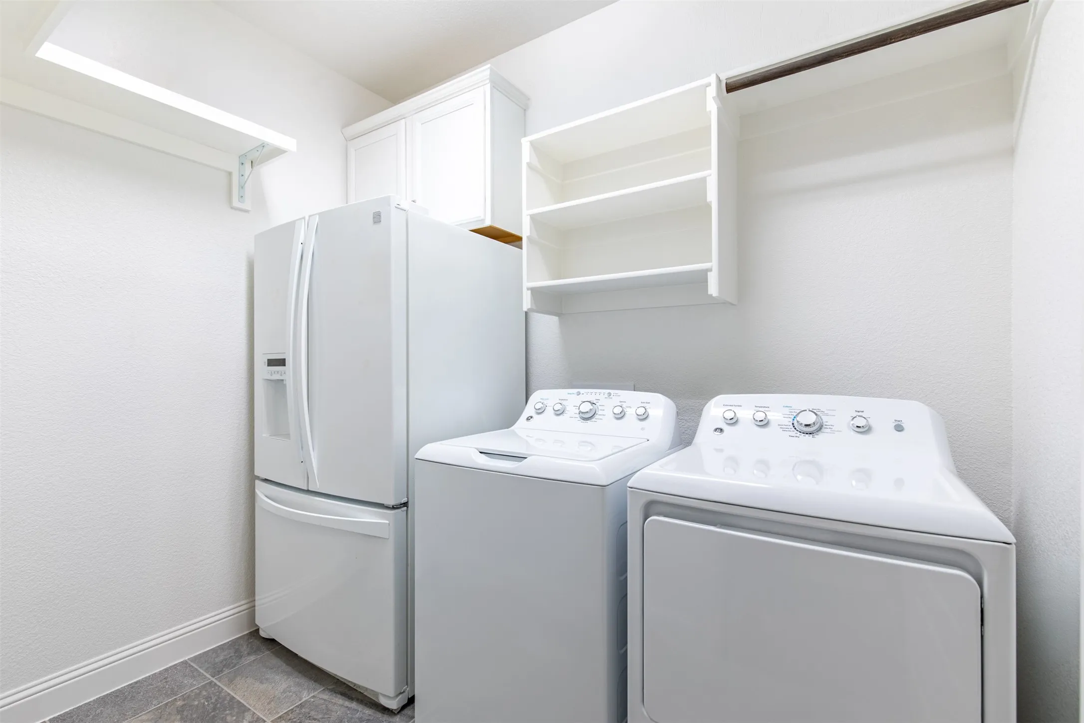 Huge laundry room with room for a refrigerator.