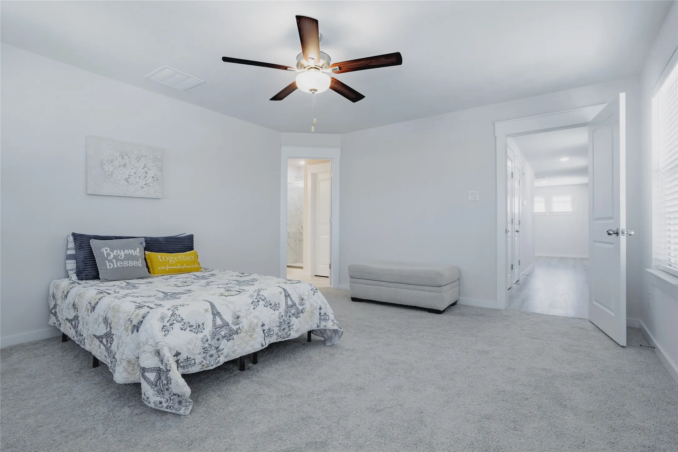 Carpeted flooring, ceiling fan, white paneled door, and window with horizontal blinds