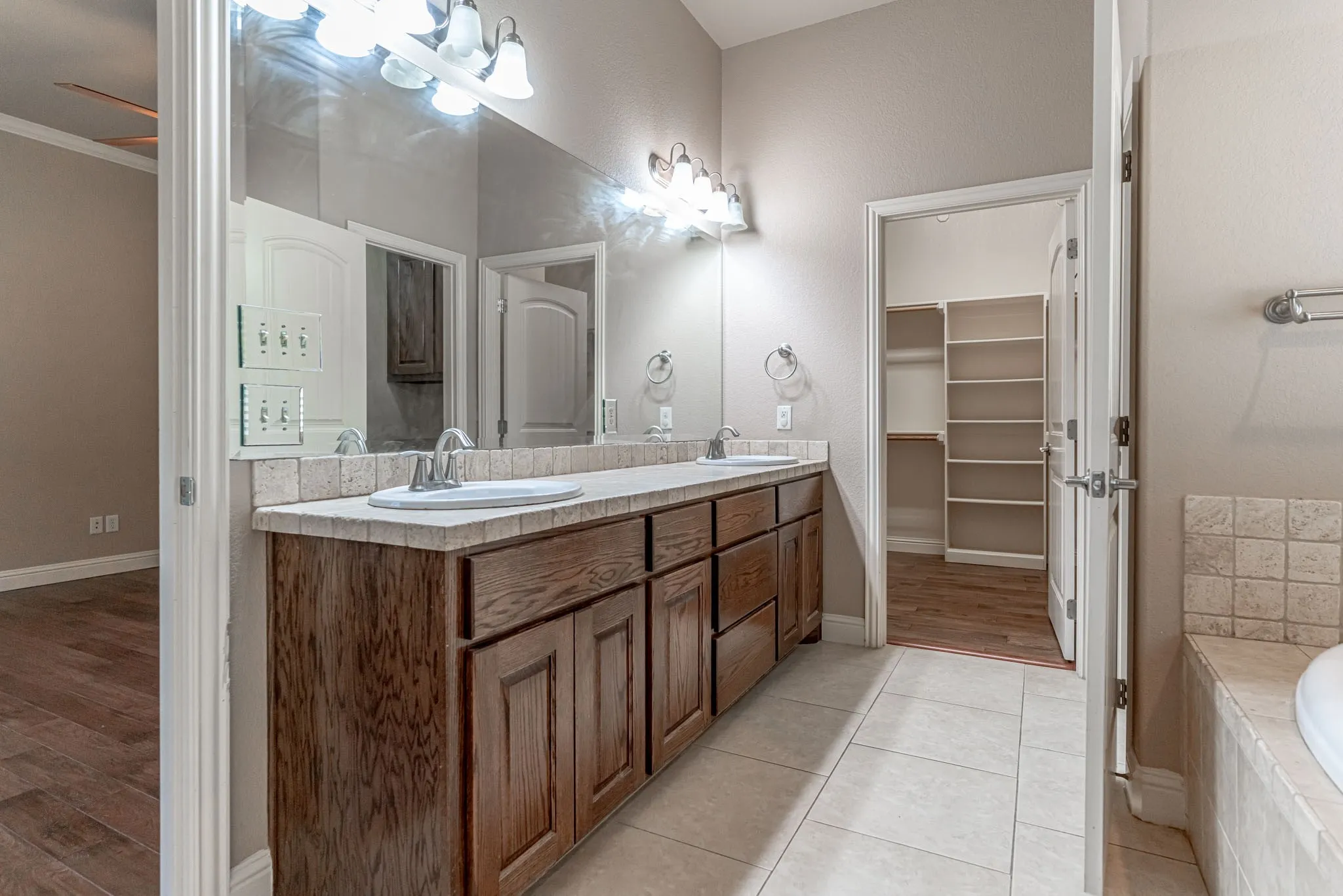 Primary bath with dual vanities and  walk in closet