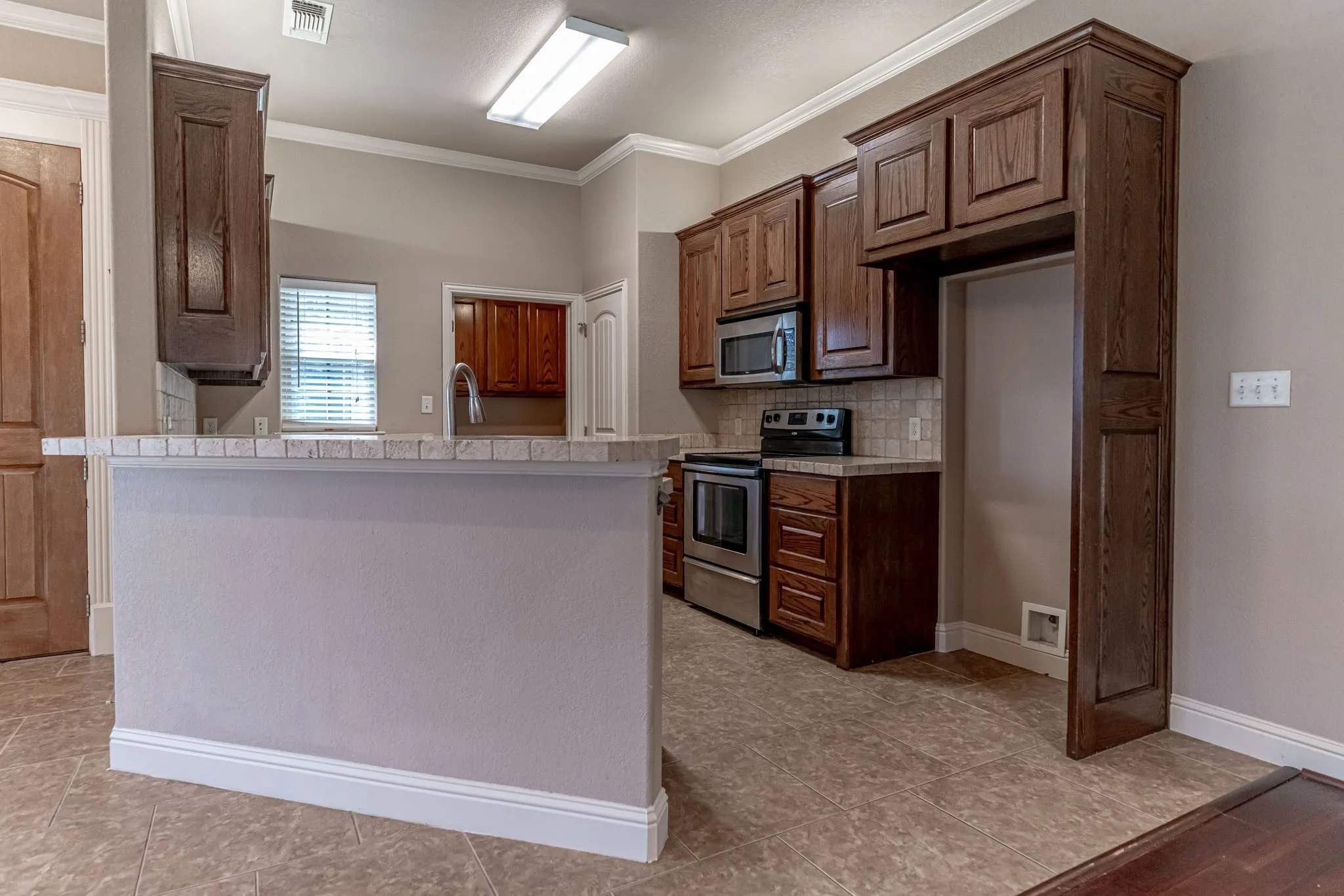 Kitchen with breakfast bar, custom cabinets and walk in pantry