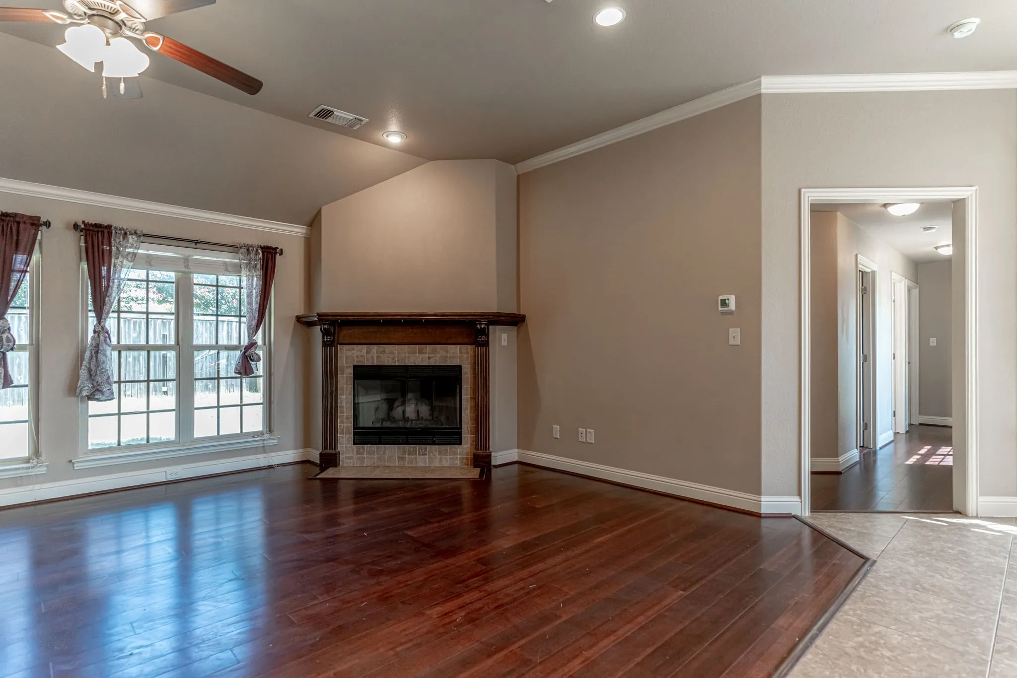 Wood buring fireplace. View of living room showing hallway to bedrooms