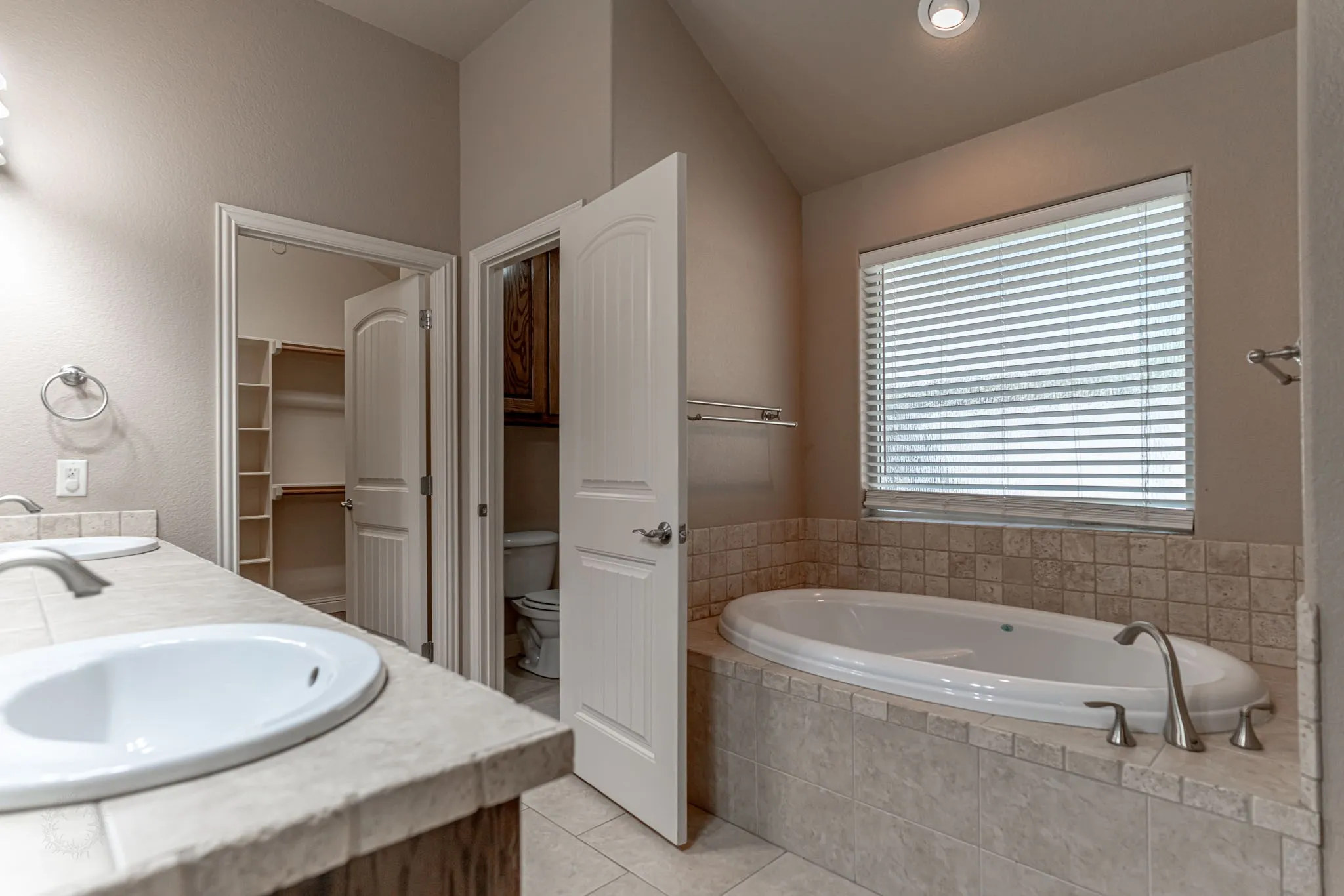 Primary bath with separate shower and walk in closet