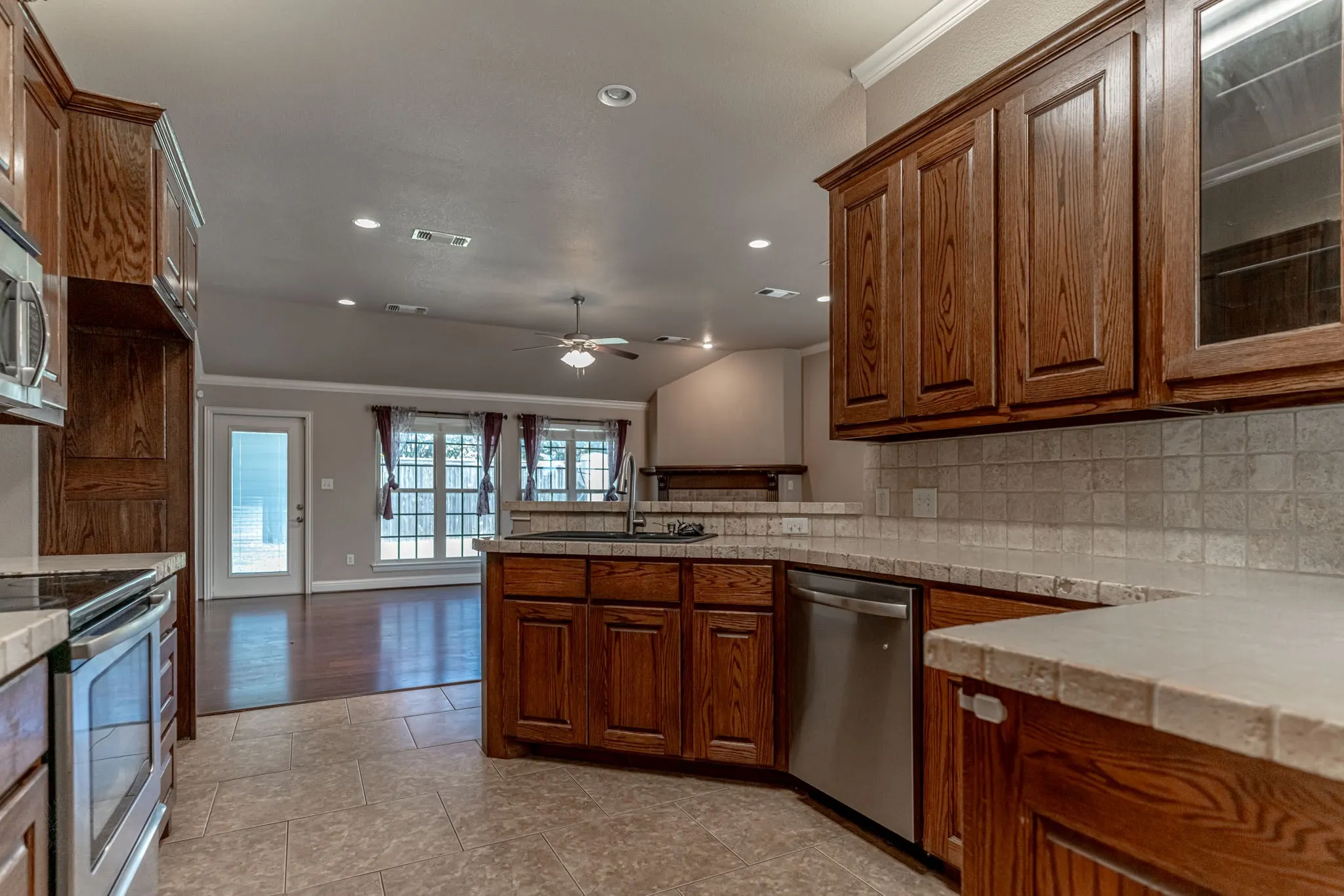 Kitchen with lots of cabinet space, tile counters and stainless appliances