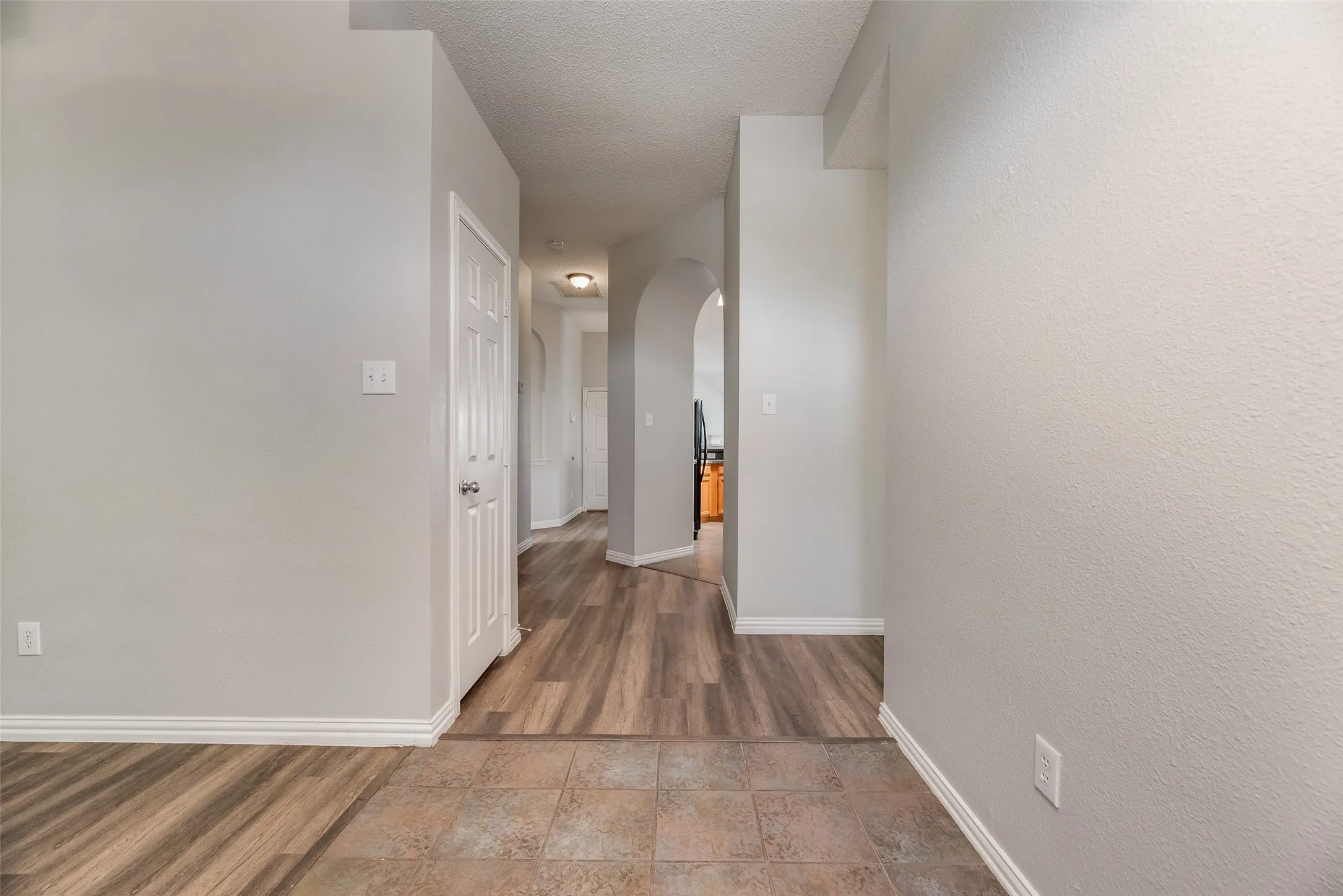Mixed material flooring with wood-finish planks and square tiles