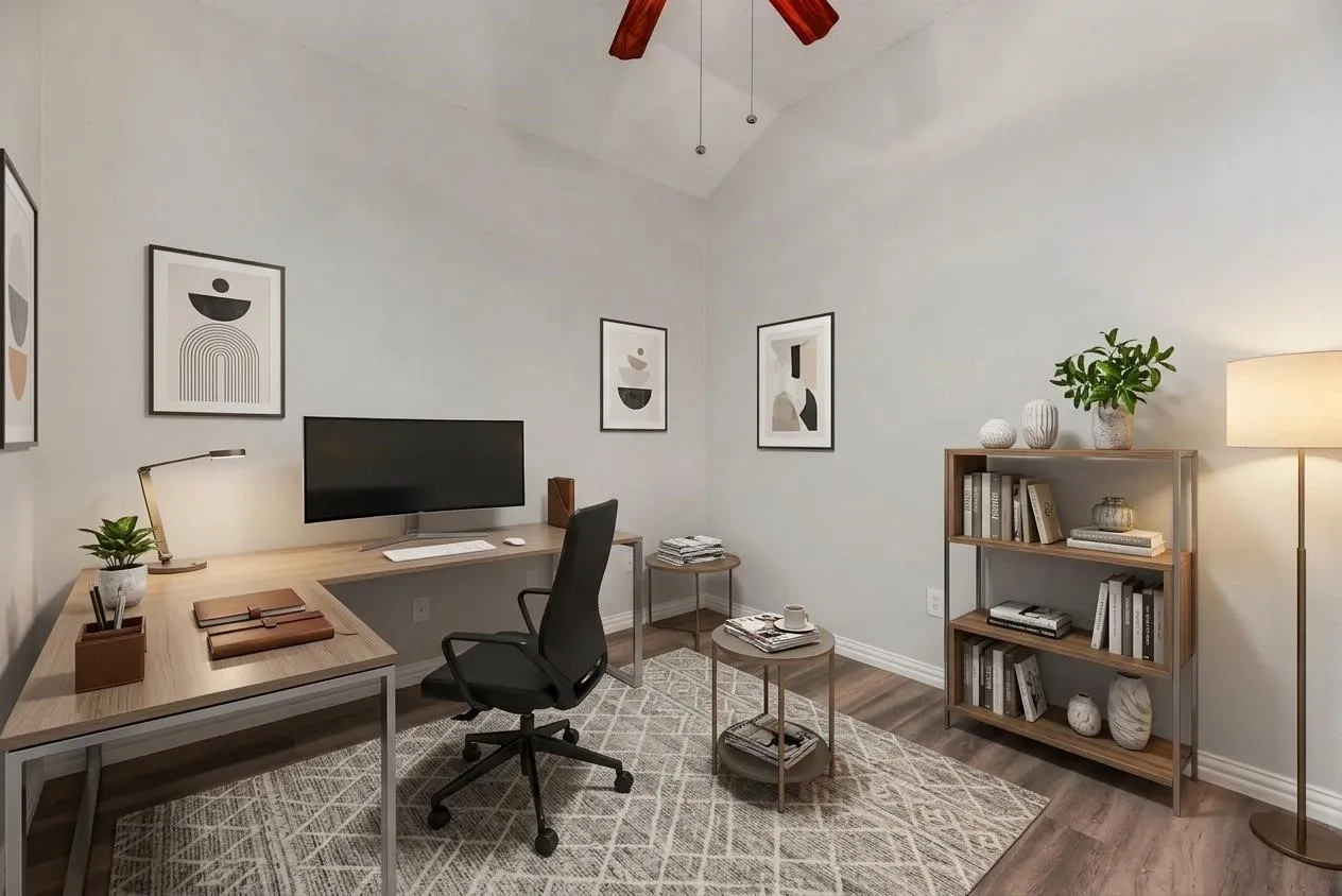 Vaulted ceiling, ceiling fan, wood-finish flooring, built-in shelving, white baseboards