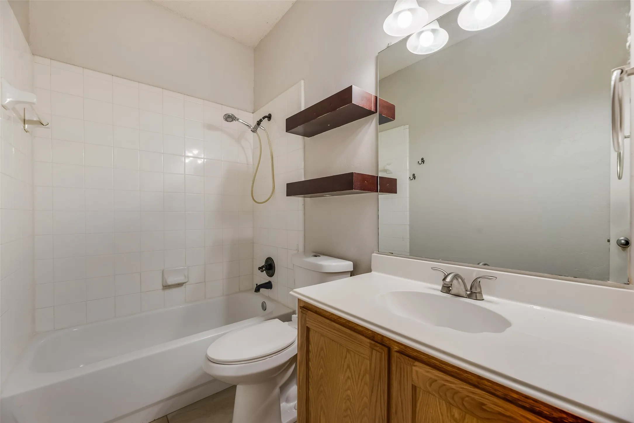 White subway tile shower surround with integrated bathtub