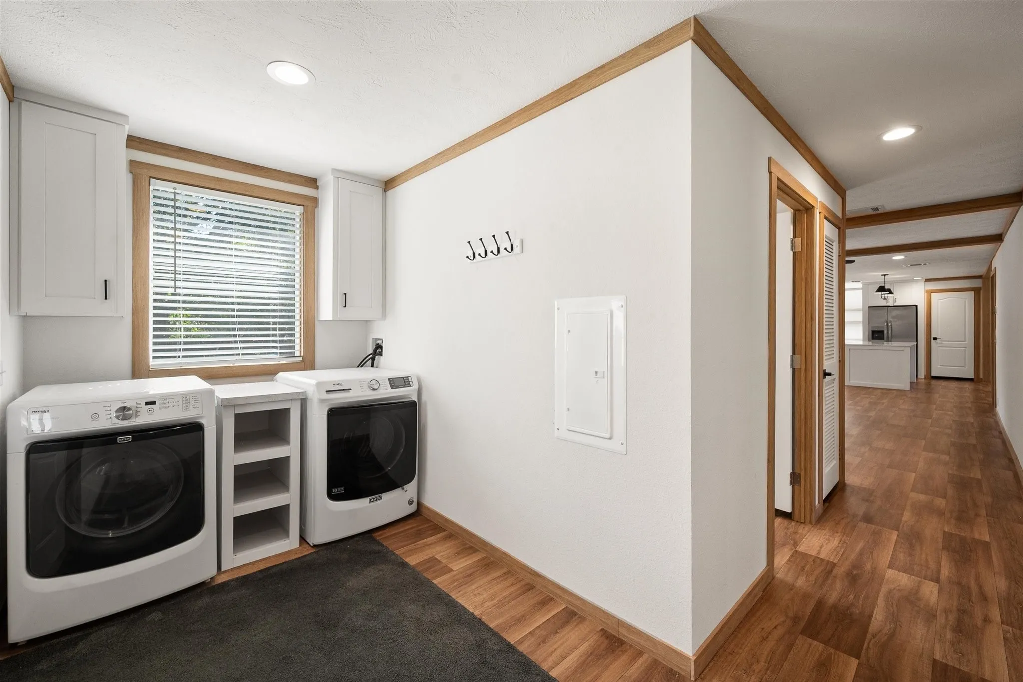 Dedicated utility room includes full-size washer and dryer space, built-in storage and convenient access from the home's hallway.