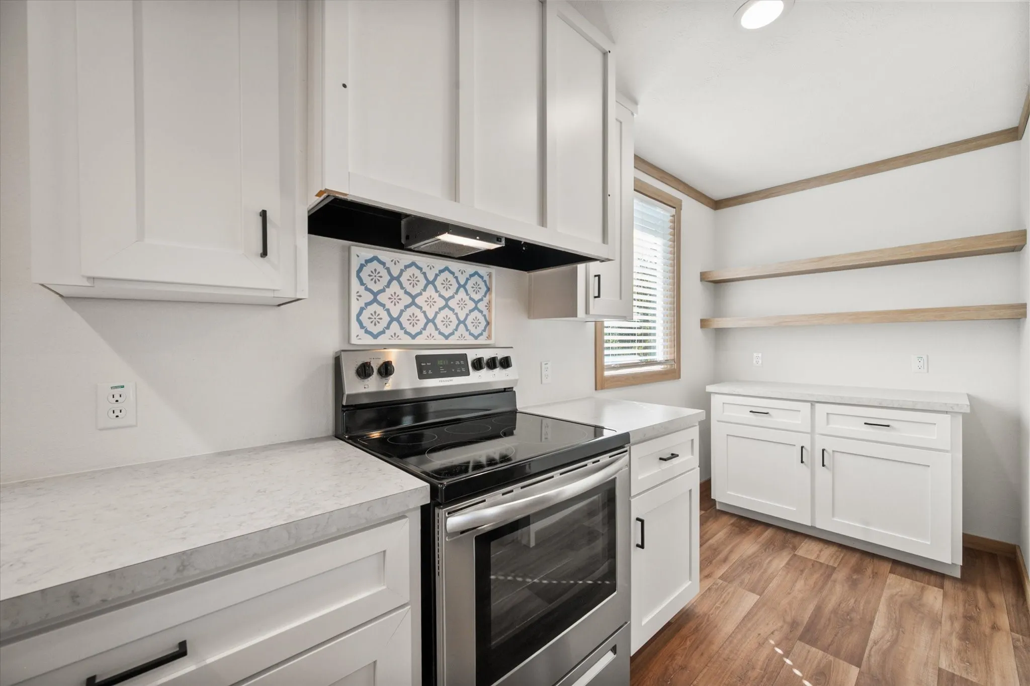 Spacious Kerens TX kitchen offers stainless steel appliances, extensive white cabinetry and convenient counter space for cooking and storage.