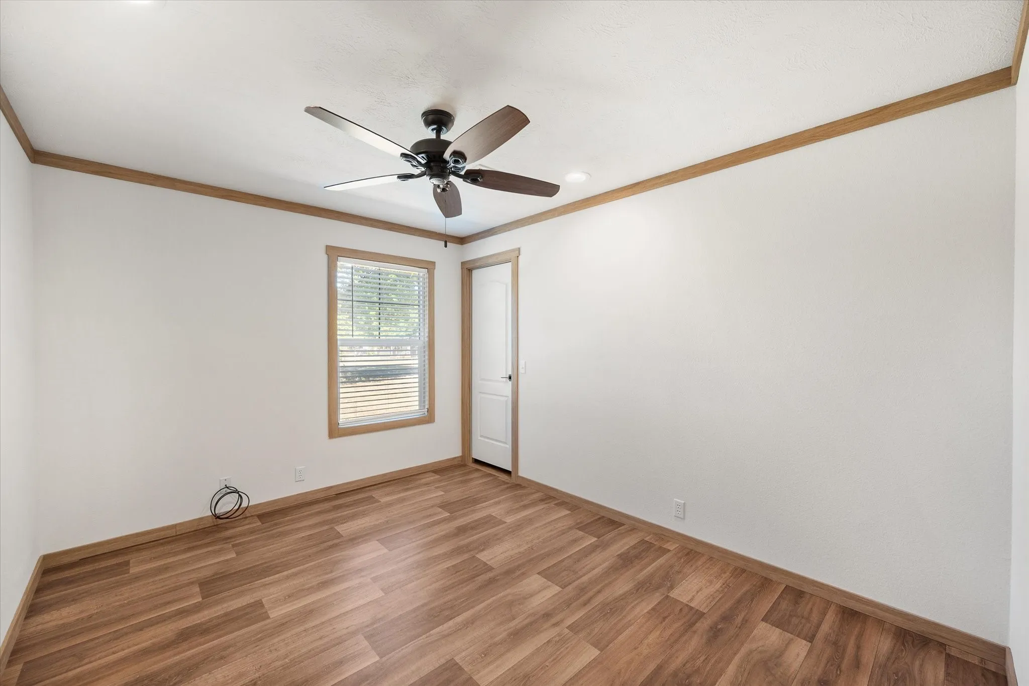 Additional Kerens TX bedroom (1) provides generous floor space, ceiling fan and a window bringing in natural light.