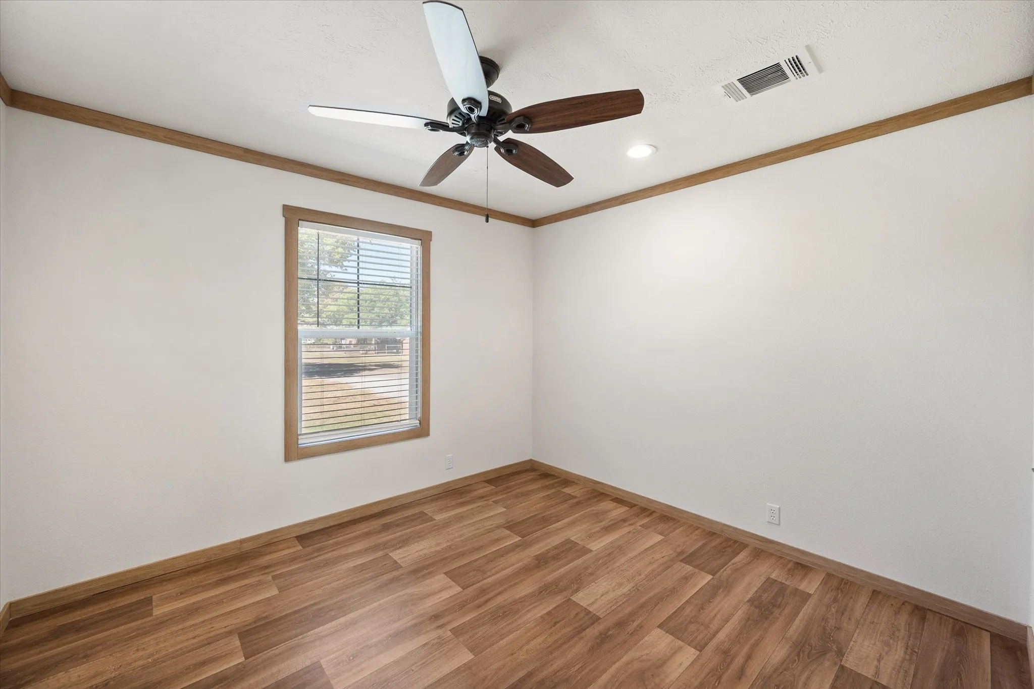 Additional bedroom (3) provides natural light, neutral finishes, ceiling fan and plenty of space for relaxation.