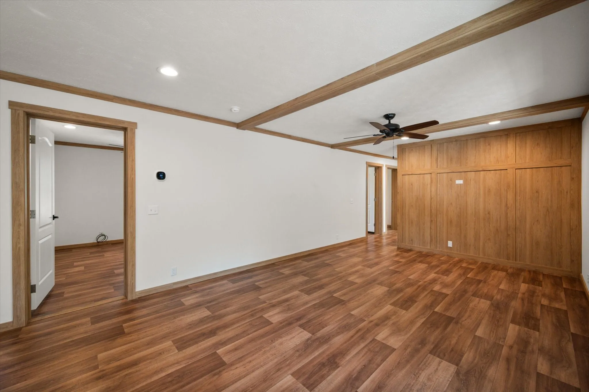 Large secondary living/dining combo space features wood-look flooring, ceiling fan, recessed lighting and built-in cabinetry for additional storage.