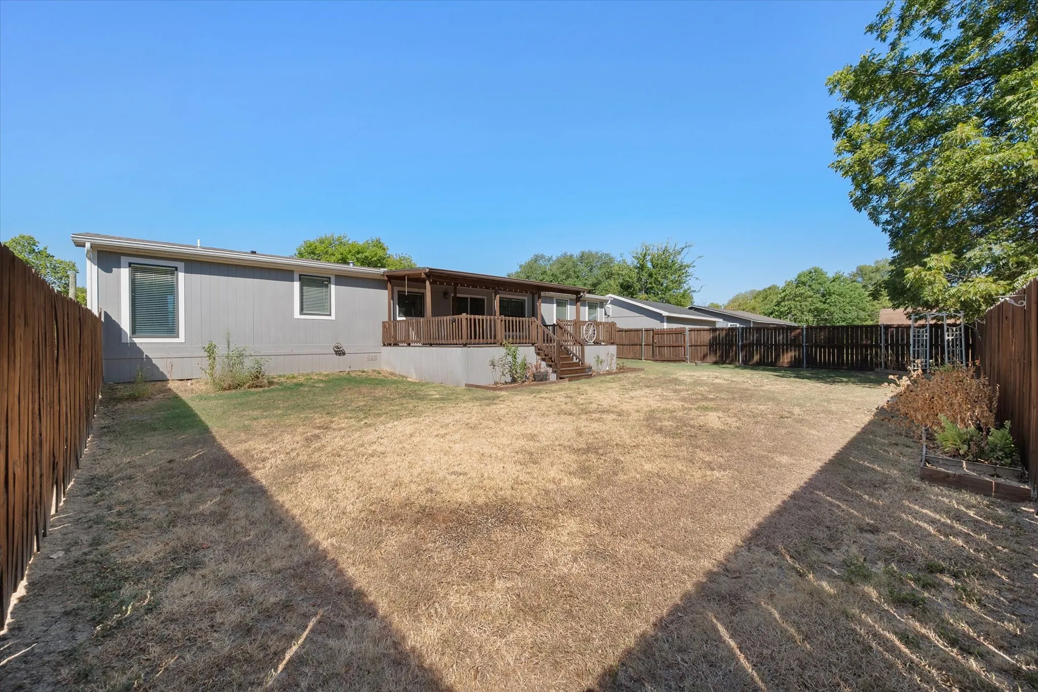 Expansive privacy-fenced backyard provides plenty of usable outdoor space for recreation, pets, gardening or future outdoor improvements.