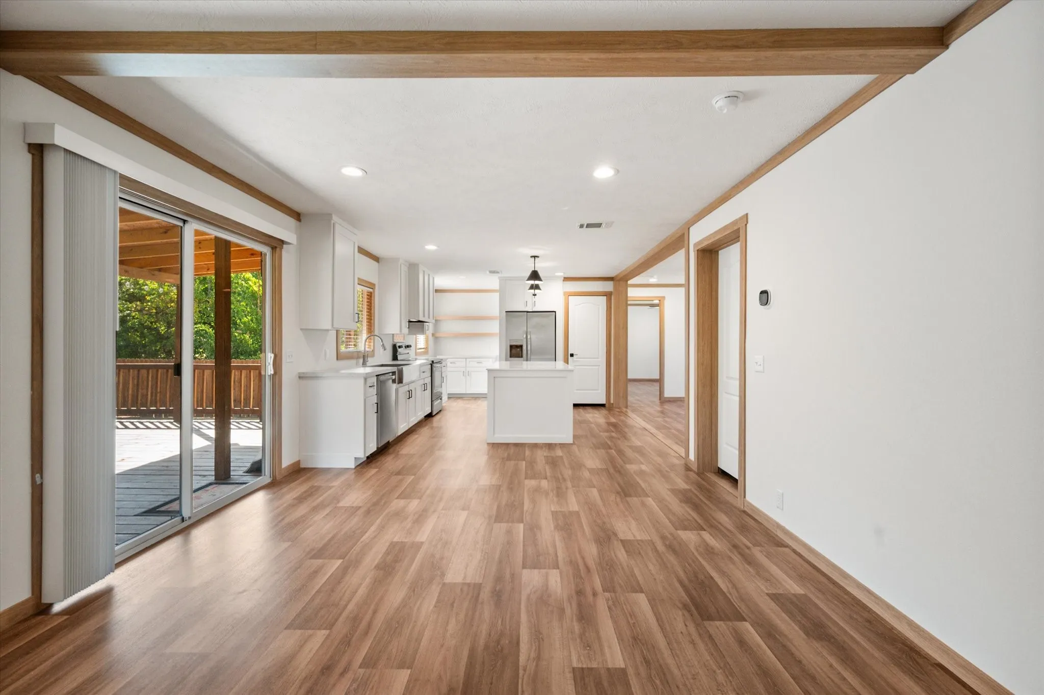 Spacious bonus living/dining area offers built-in storage, large windows and direct access to the covered backyard deck.