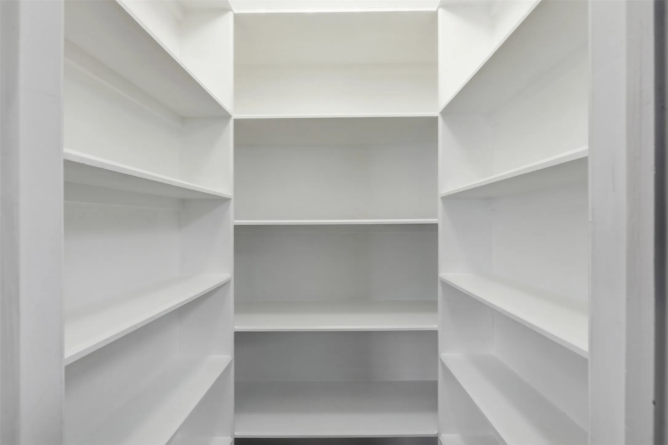 White-painted shelving with multiple levels of storage