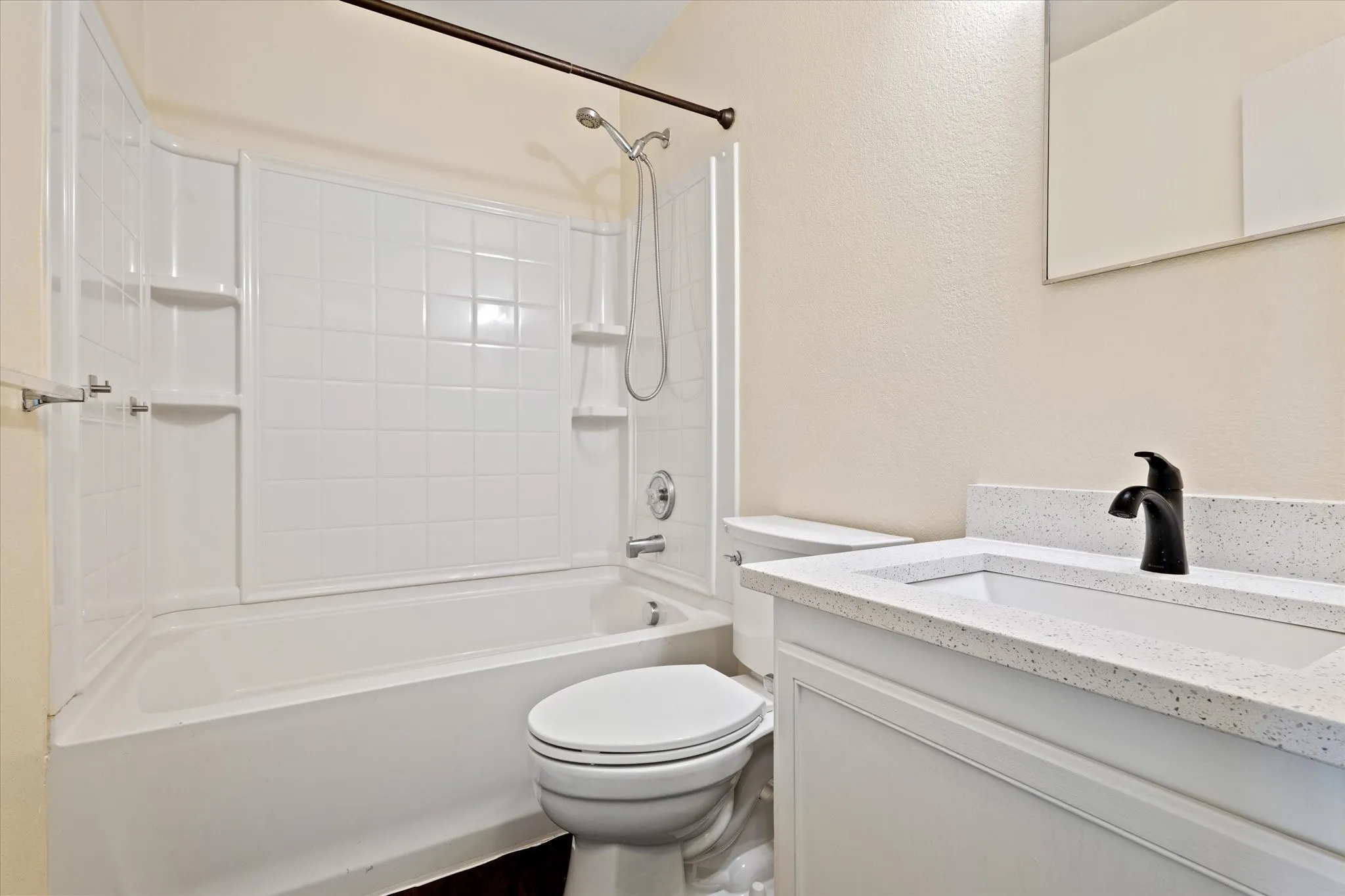 Bathroom featuring vanity and  shower combination