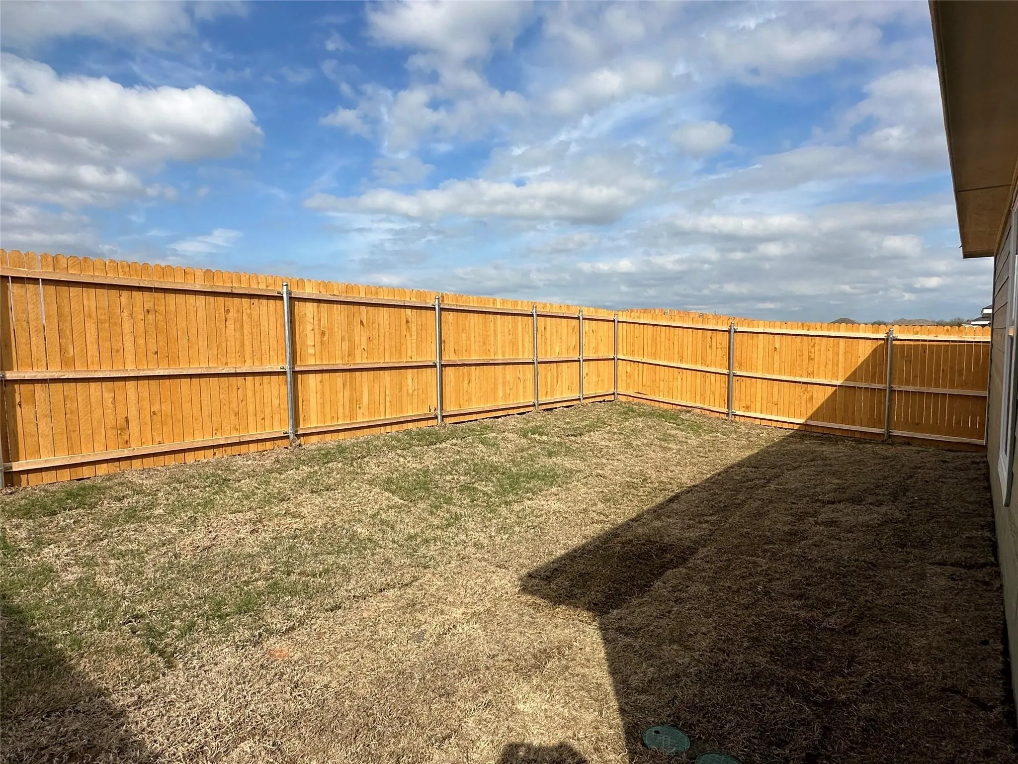 Fenced backyard with wood privacy fencing