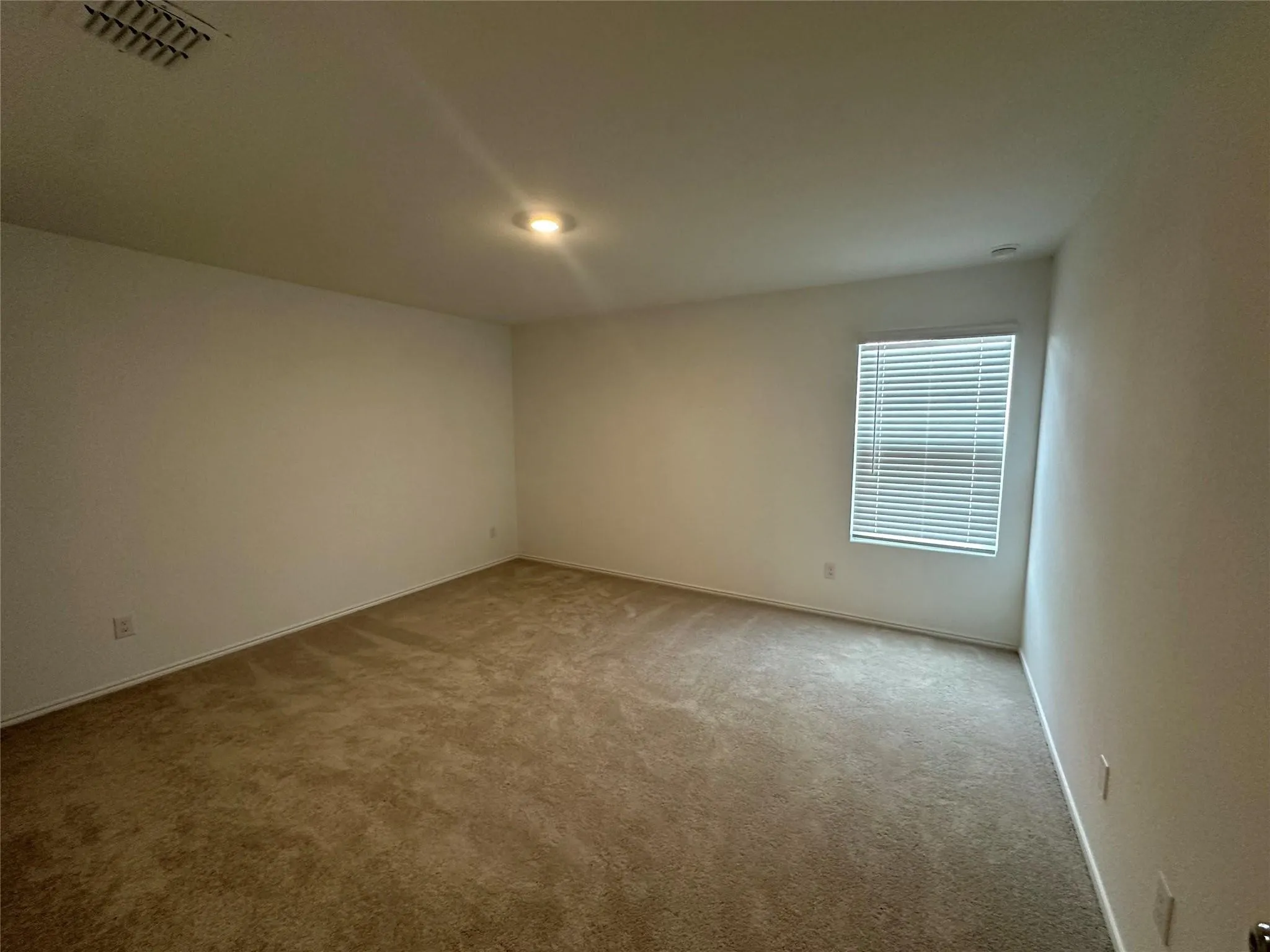 Carpeted interior room featuring a window with horizontal blinds, recessed lighting, and a ceiling-mounted air​​‌​​​​‌​​‌‌​‌‌​​​‌‌​‌​‌​‌​​​‌​​ vent