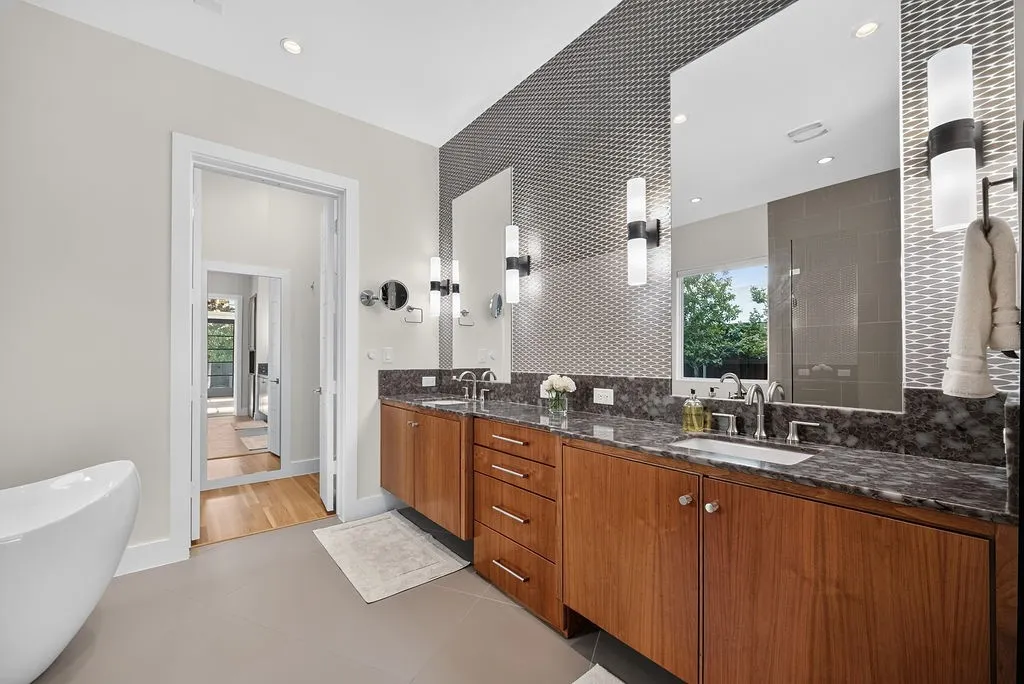 Dual vanities and a frameless glass shower offer plenty of room for two during busy mornings