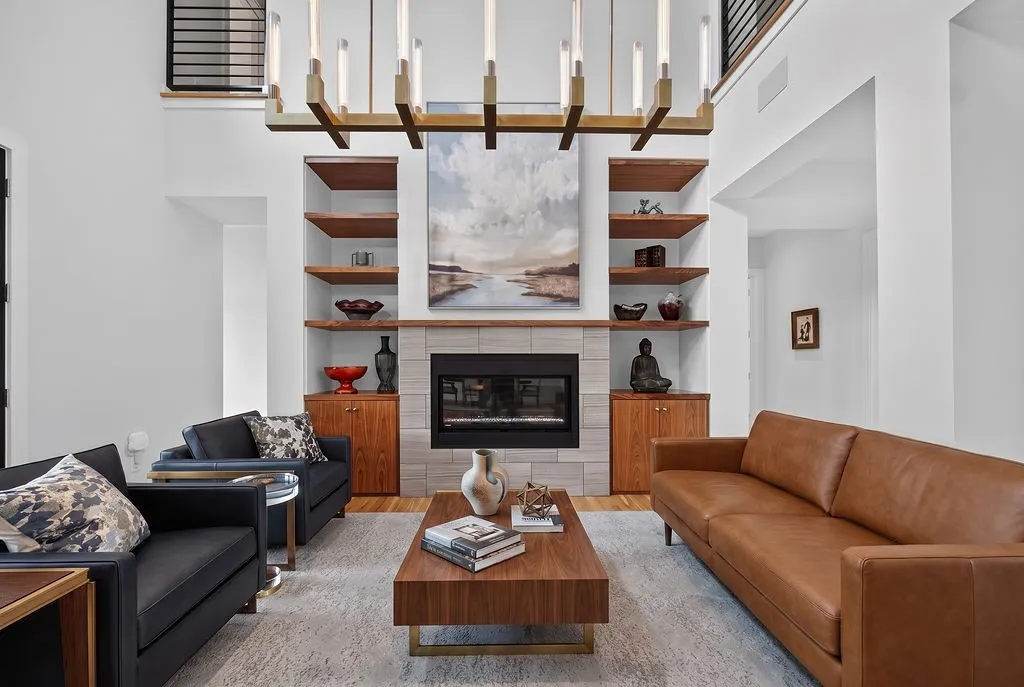 Flooded with natural light through floor-to-ceiling windows, the formal living room offers a quiet space for conversation