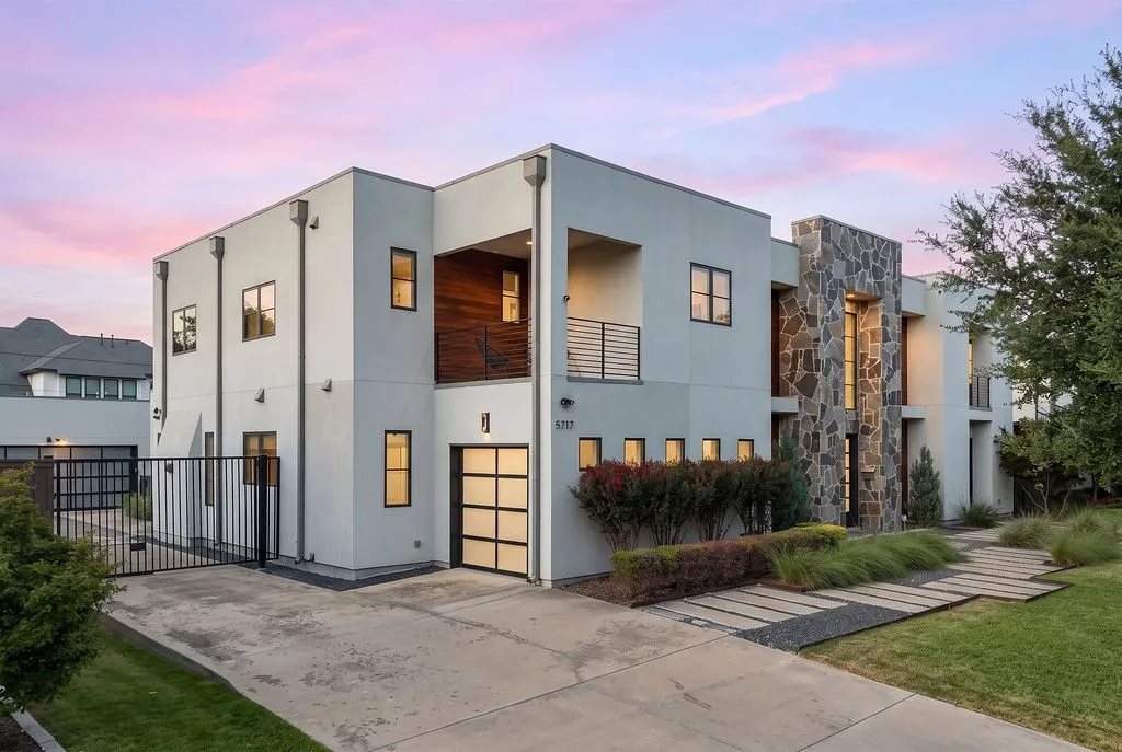 Framed by mature trees and a gated driveway, this custom estate introduces a warm, welcoming presence
