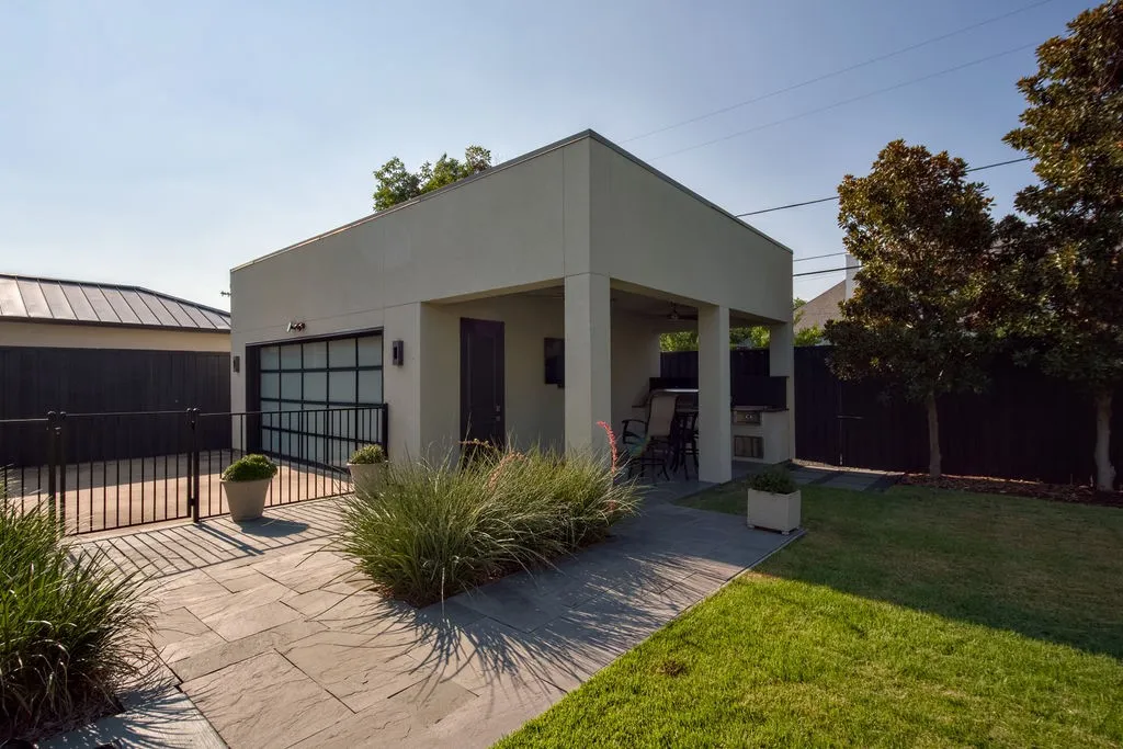 A gated driveway leads around to a side-entry 3-car garage with plenty of room for vehicles and extra storage