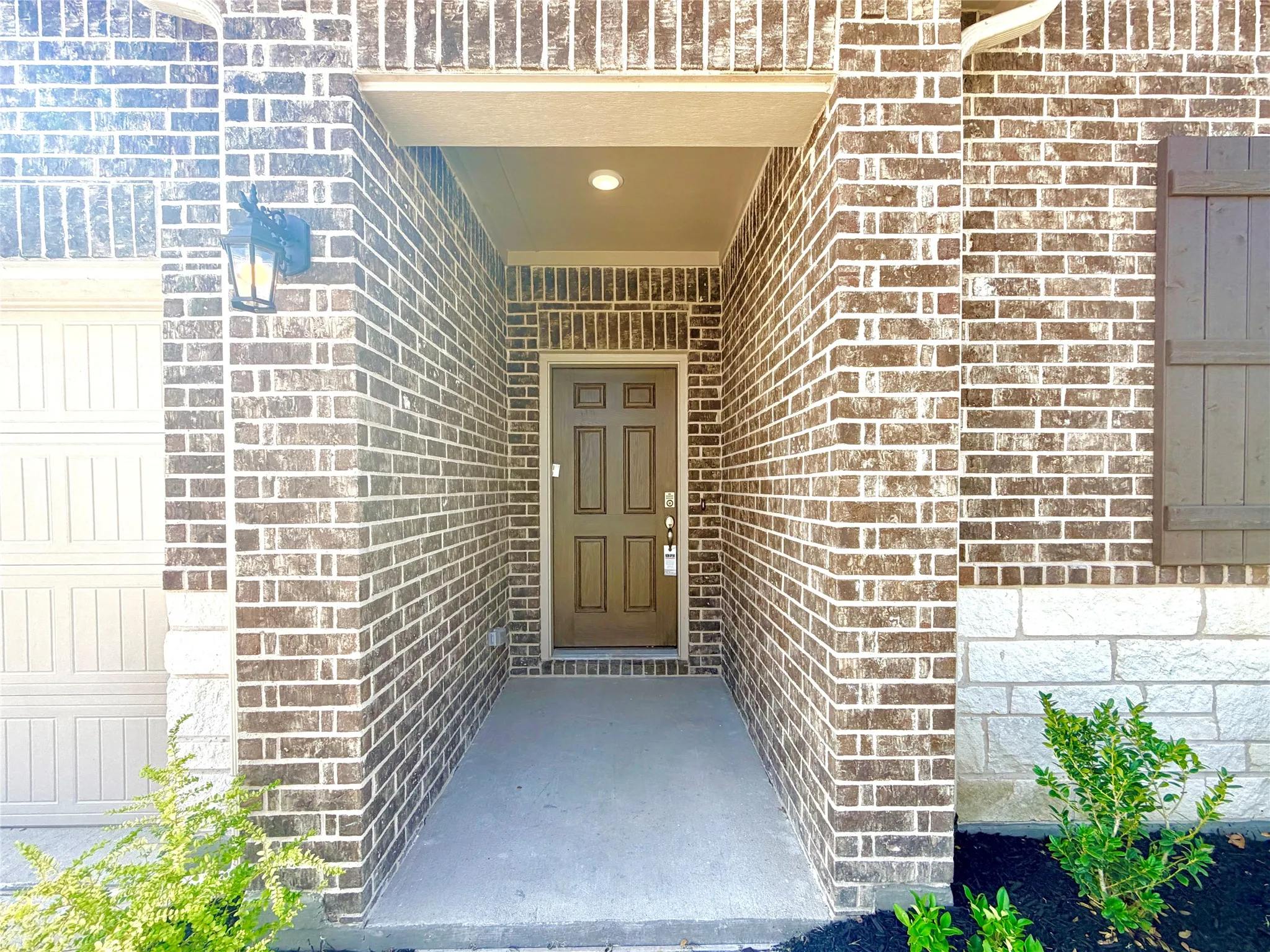 Brick exterior with stone accents and a covered entryway