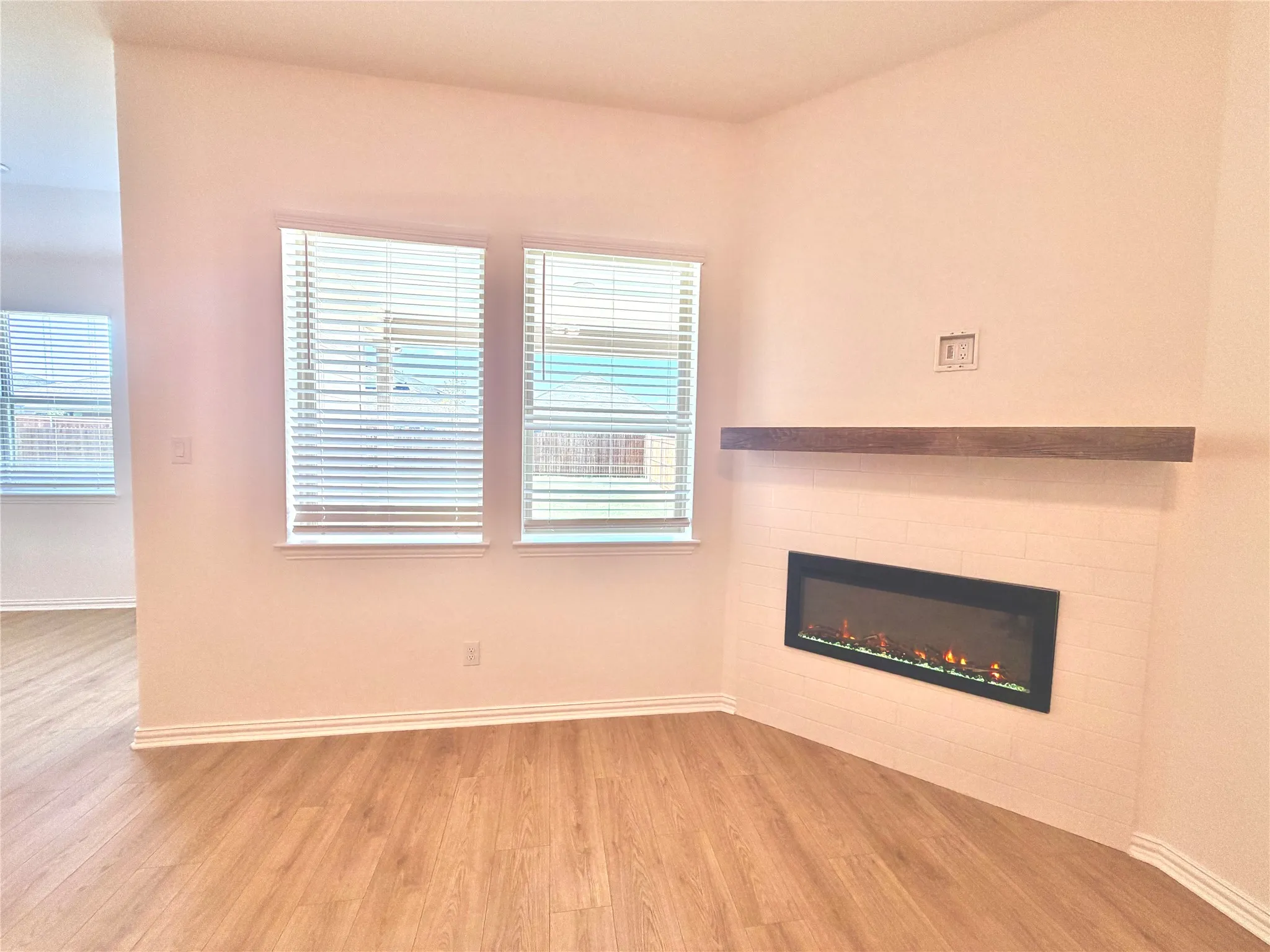 Electric fireplace with a wood-finish mantel and a tile surround