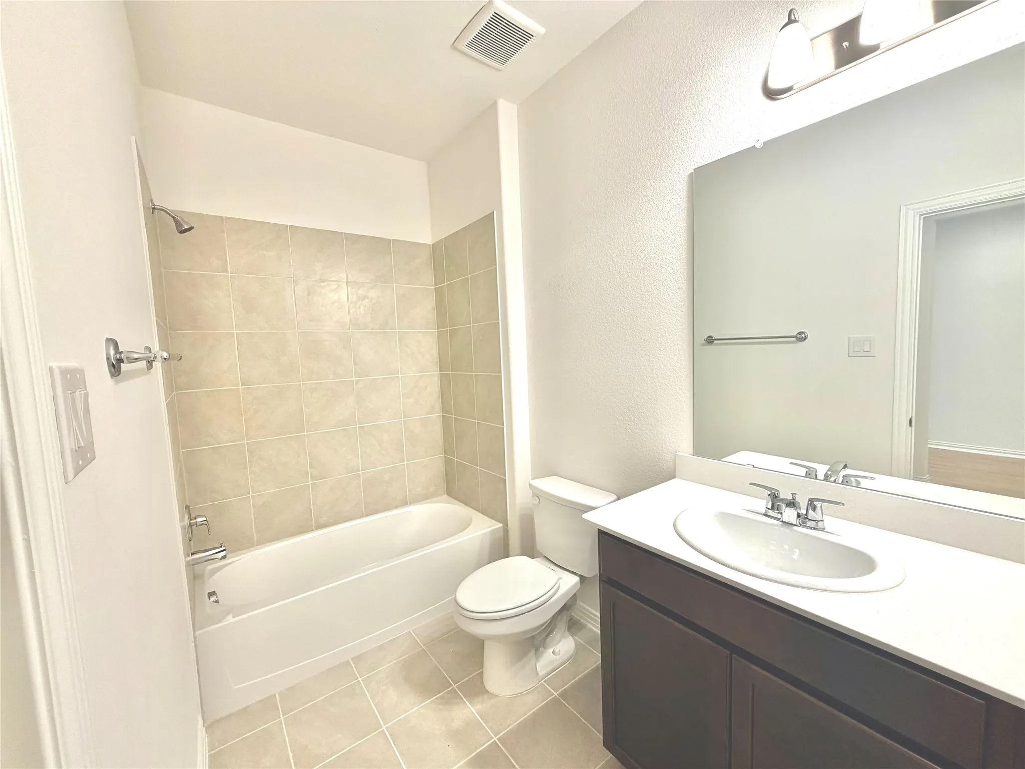 Full vanity with an integrated sink, polished chrome faucet, and dark wood-finish cabinetry