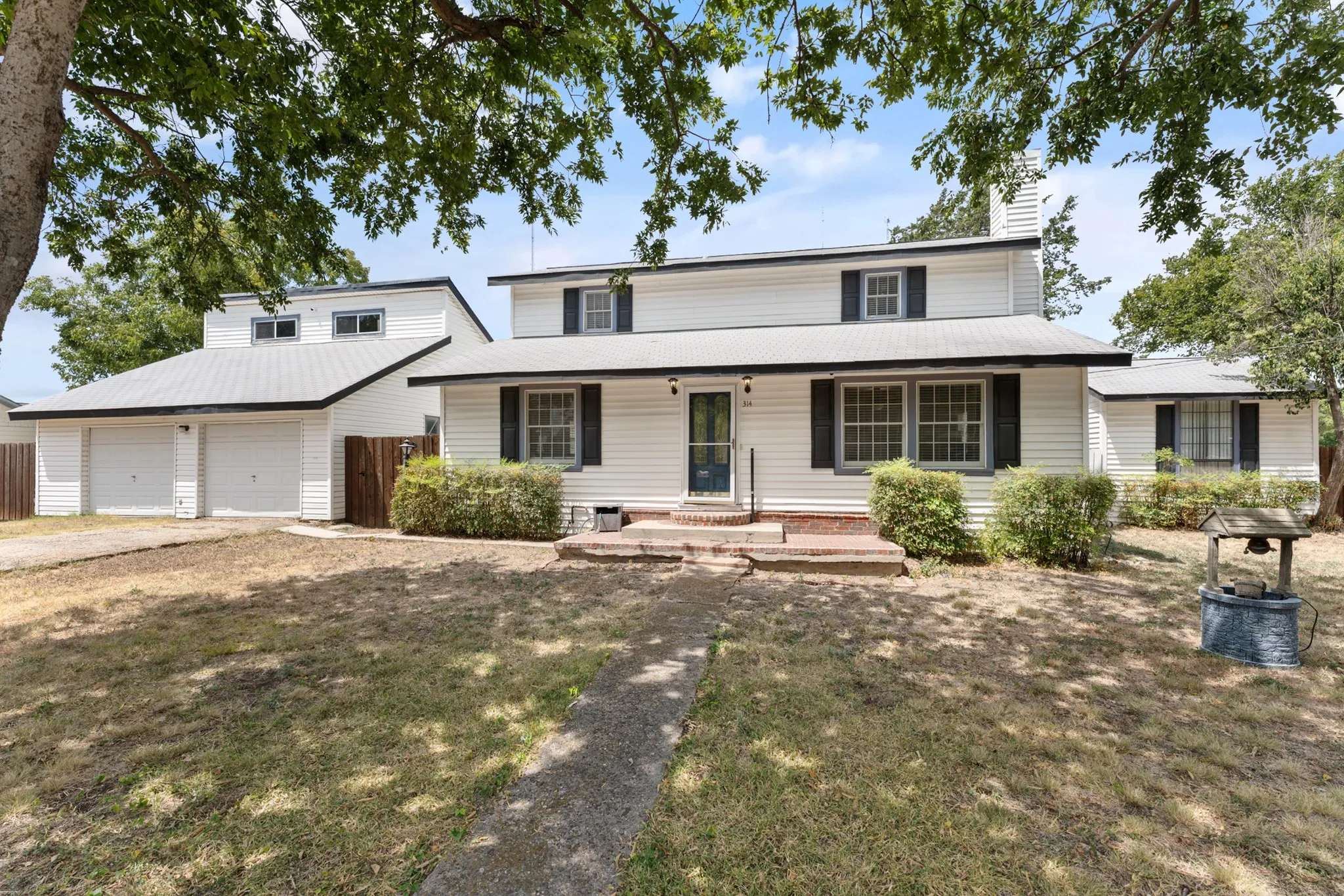 White siding exterior with black window shutters