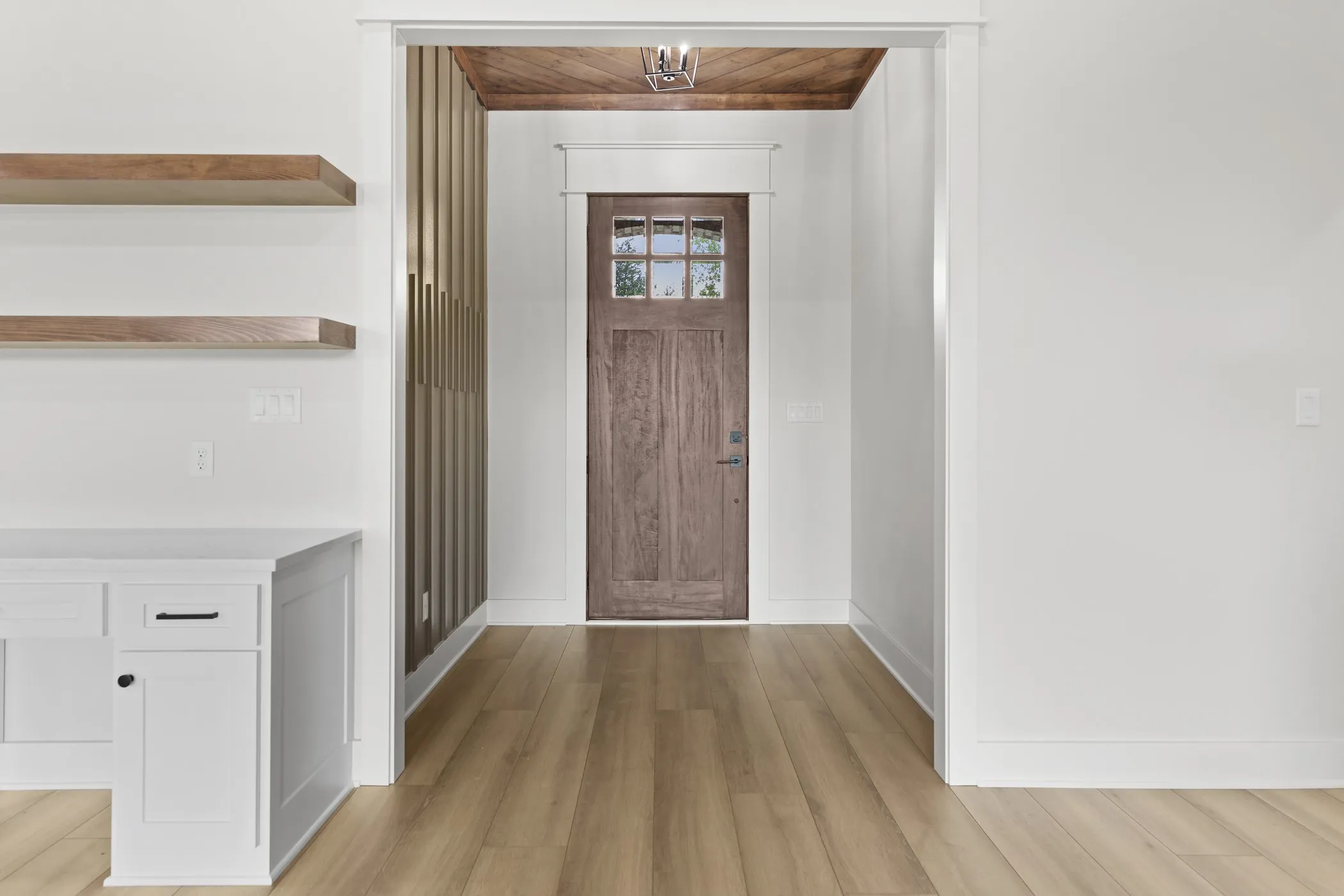 Wood-finish flooring throughout, framed by white baseboards