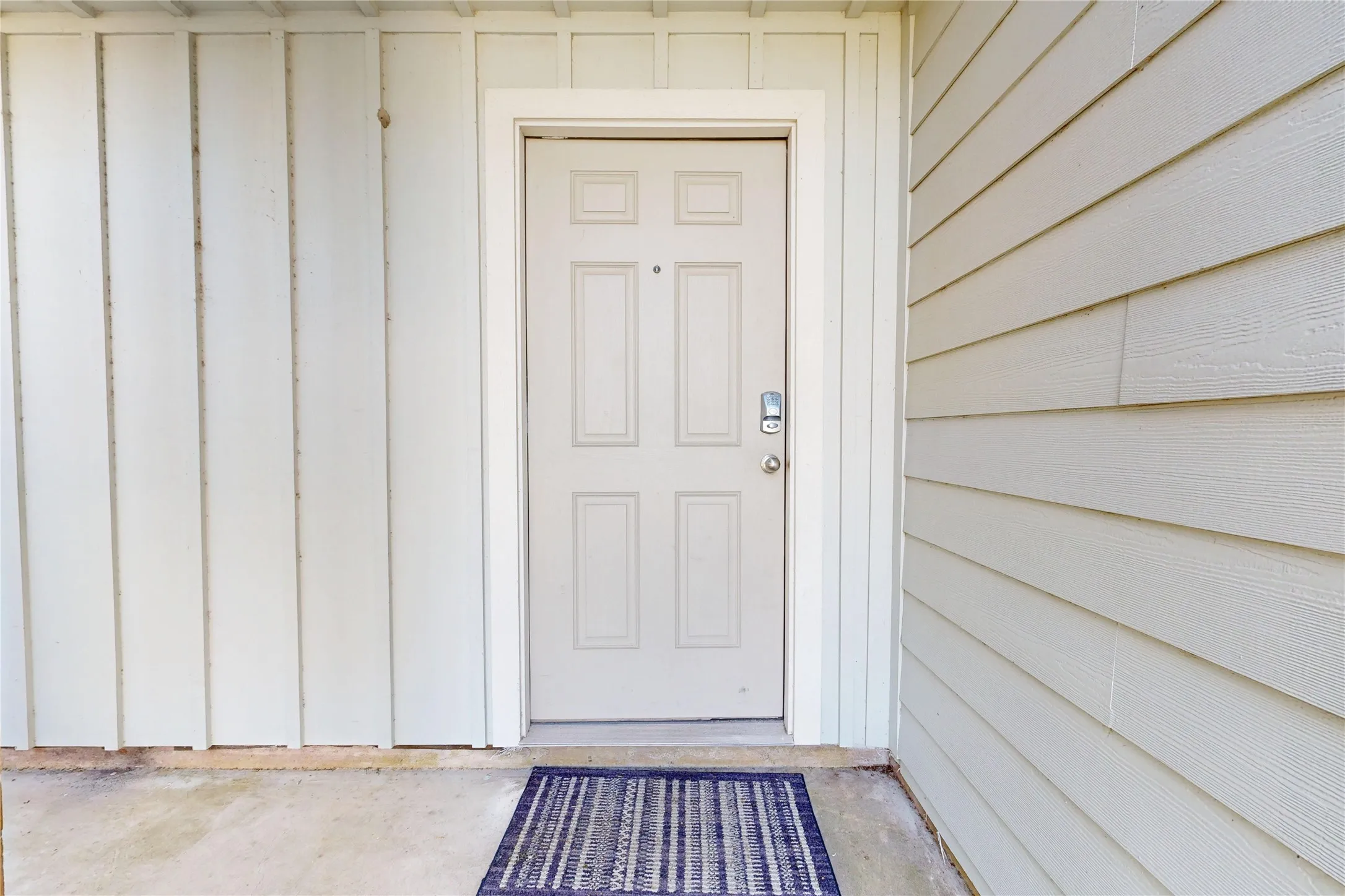 Entry door with smart lock hardware and paneled design