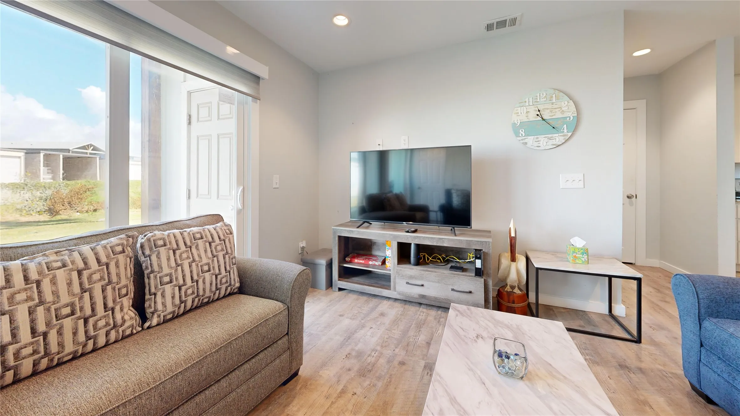 Recessed ceiling lighting, wood-finish flooring, and light-toned wall paint