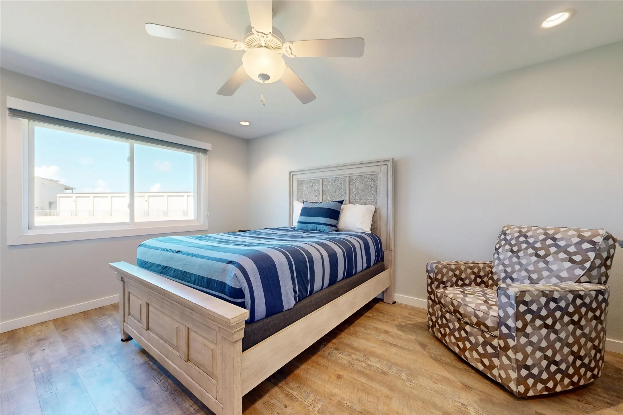 Wood-finish flooring, recessed lighting, and a ceiling fan with integrated light