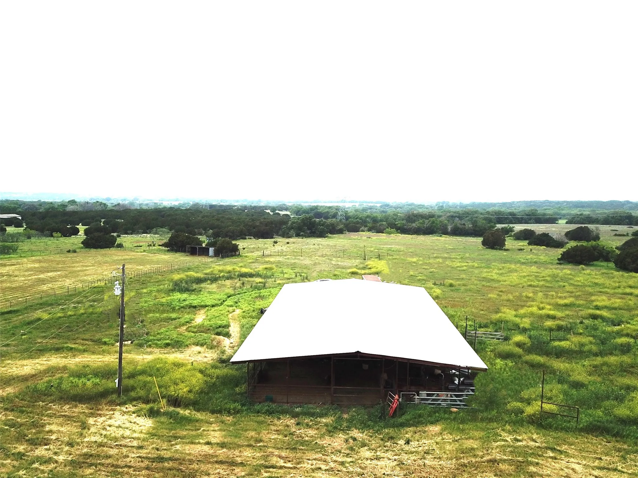 Entry to storm shelter with an outdoor structure and a rural view