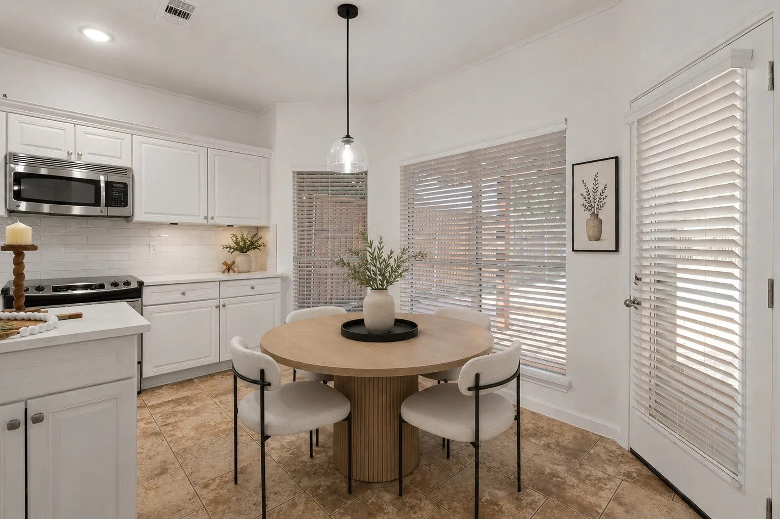 Virtually staged eat-in kitchen with a bright, inviting feel.