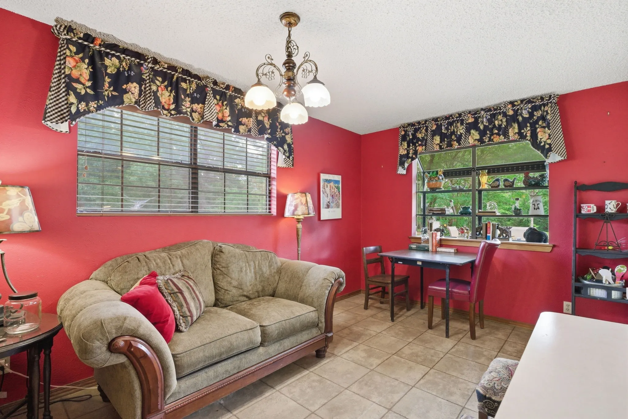 Tile flooring, multiple windows providing natural illumination, and a ceiling-mounted light fixture