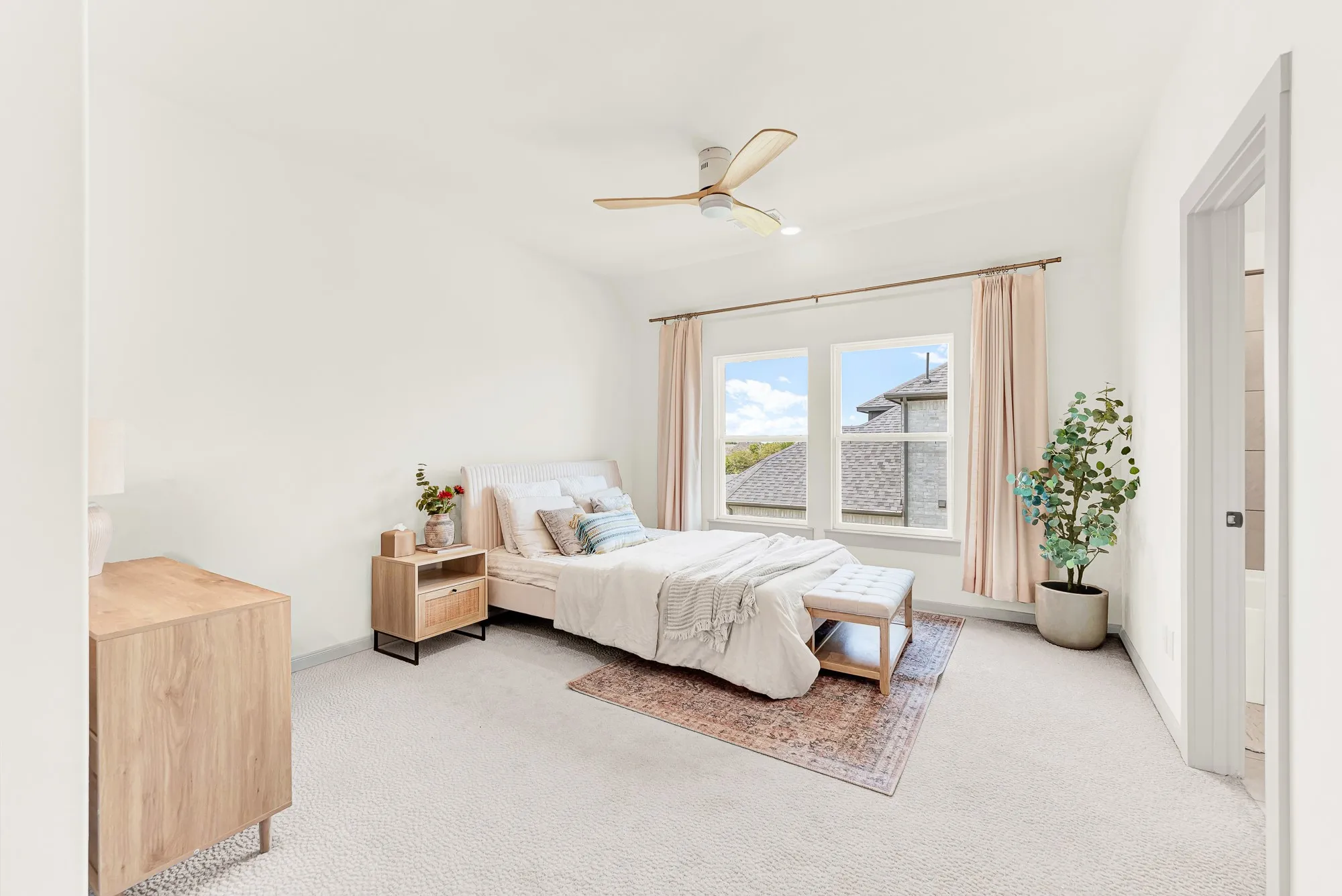 A tall framed doorway opens smoothly into a spacious, light-filled sleeping sanctuary. Teenagers or overnight visitors can enjoy peaceful late-night relaxation with plenty of room to stretch out