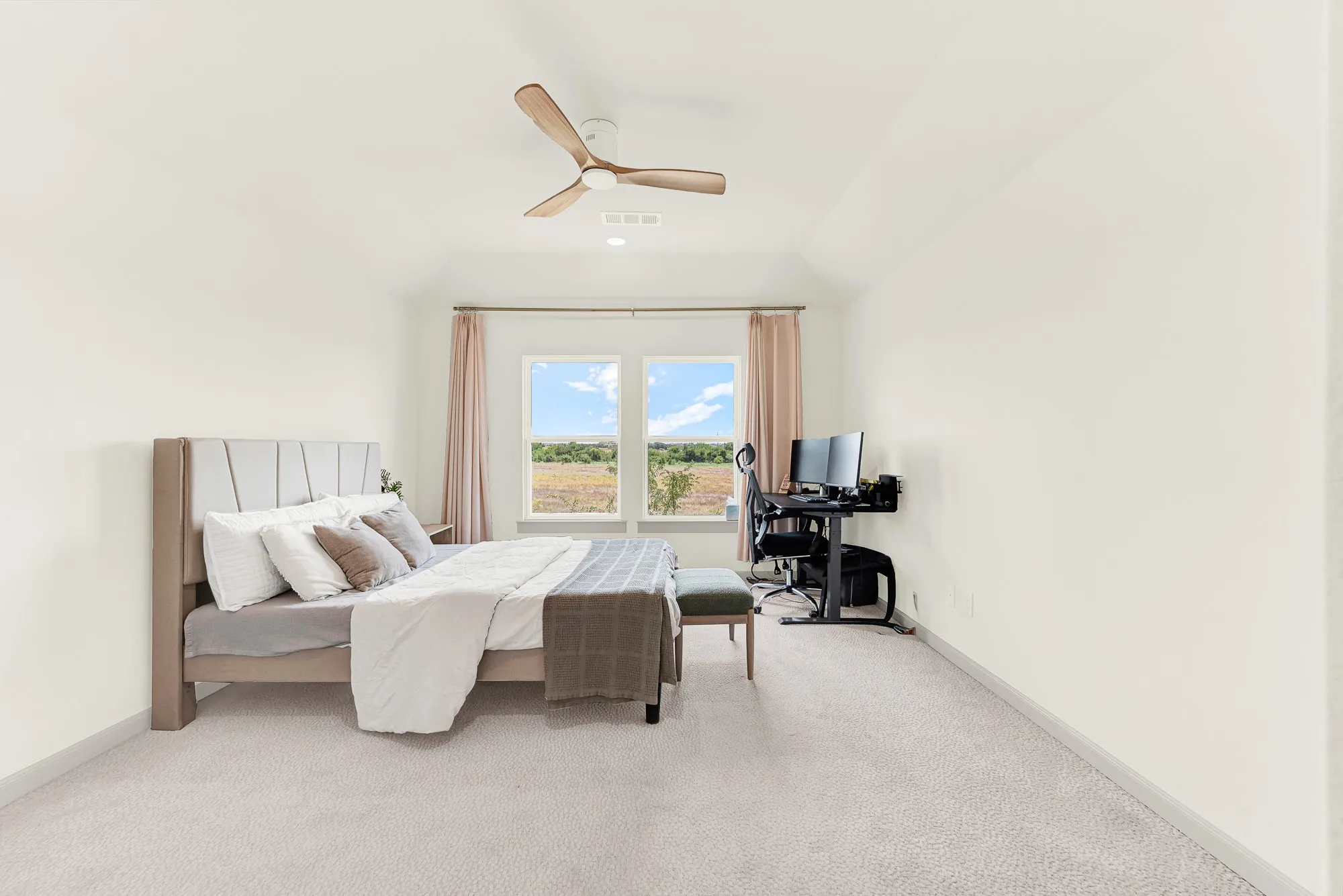 Slightly sloped ceilings and framed double windows direct natural light straight across the deep room layout. It offers an easy space to focus on homework or dive into a favorite book during quiet afternoon hours.