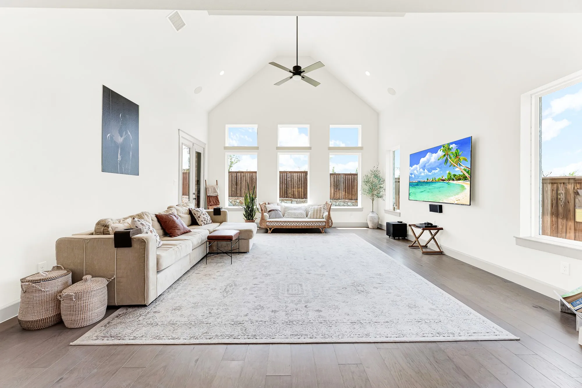 Dramatic cathedral ceilings and a trio of tall rear windows draw sunshine deep into the spacious room. It’s a cozy setting for family movie nights or curling up with a good book.