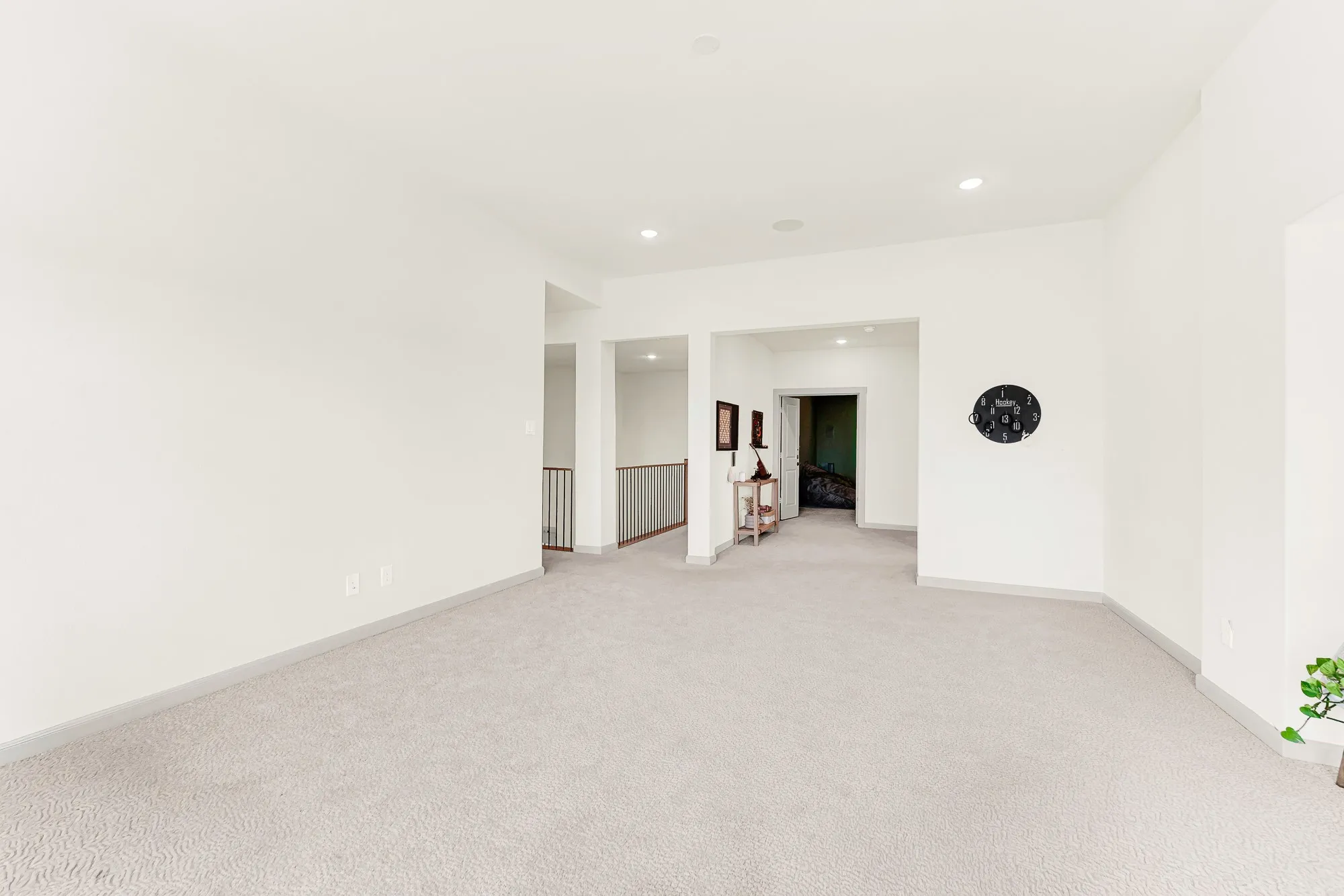 Clean, crisp walls and open passageways create an effortless connection to the rest of the upper level. It is the perfect spot for family game nights that casually spill out into adjacent spaces.