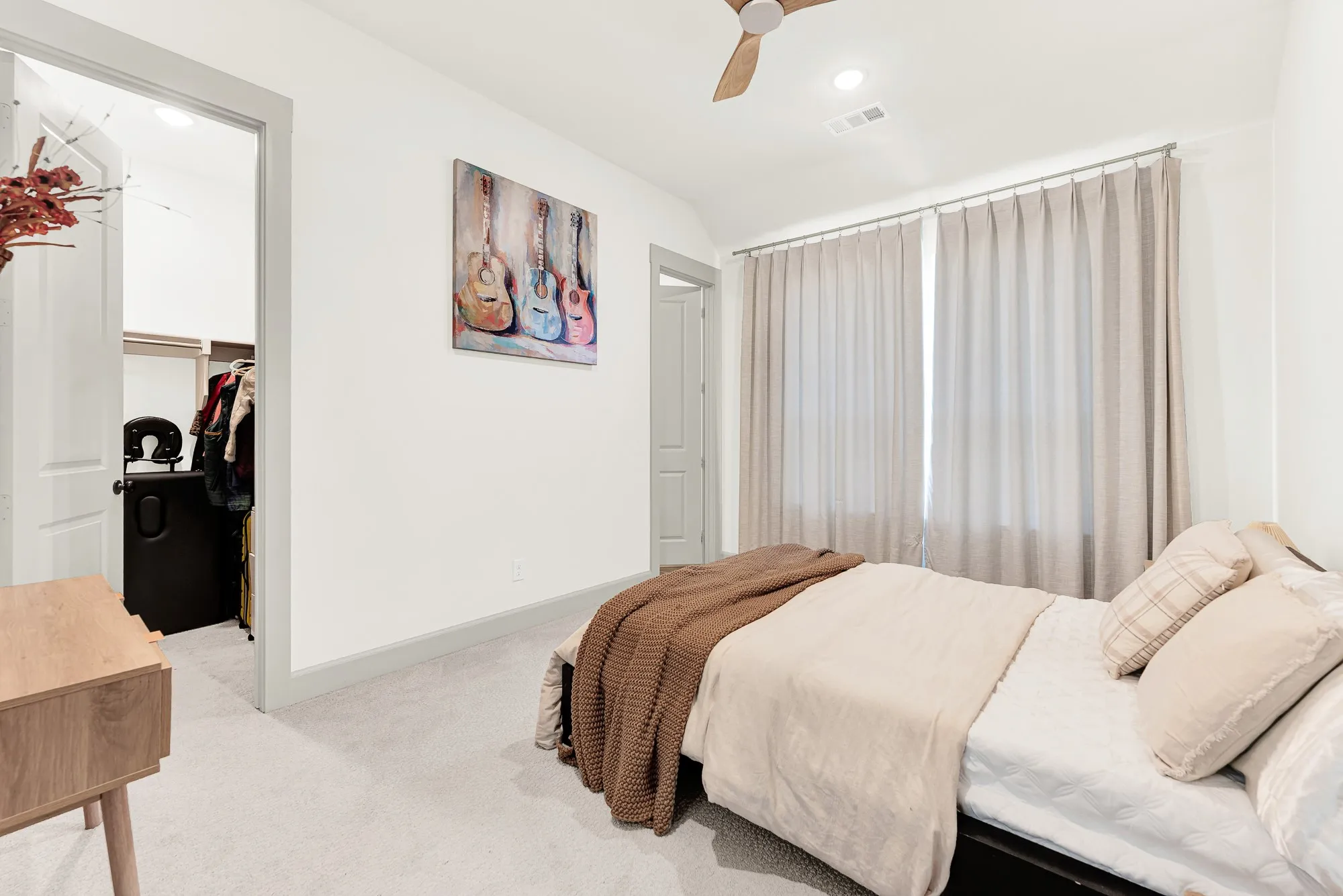 Expansive windows flood the space with gentle natural light, accentuating the crisp, clean trim and airy high ceiling structure. Guests can sleep in total peacefulness, waking up refreshed to a slow, sunlit morning right on the main level.