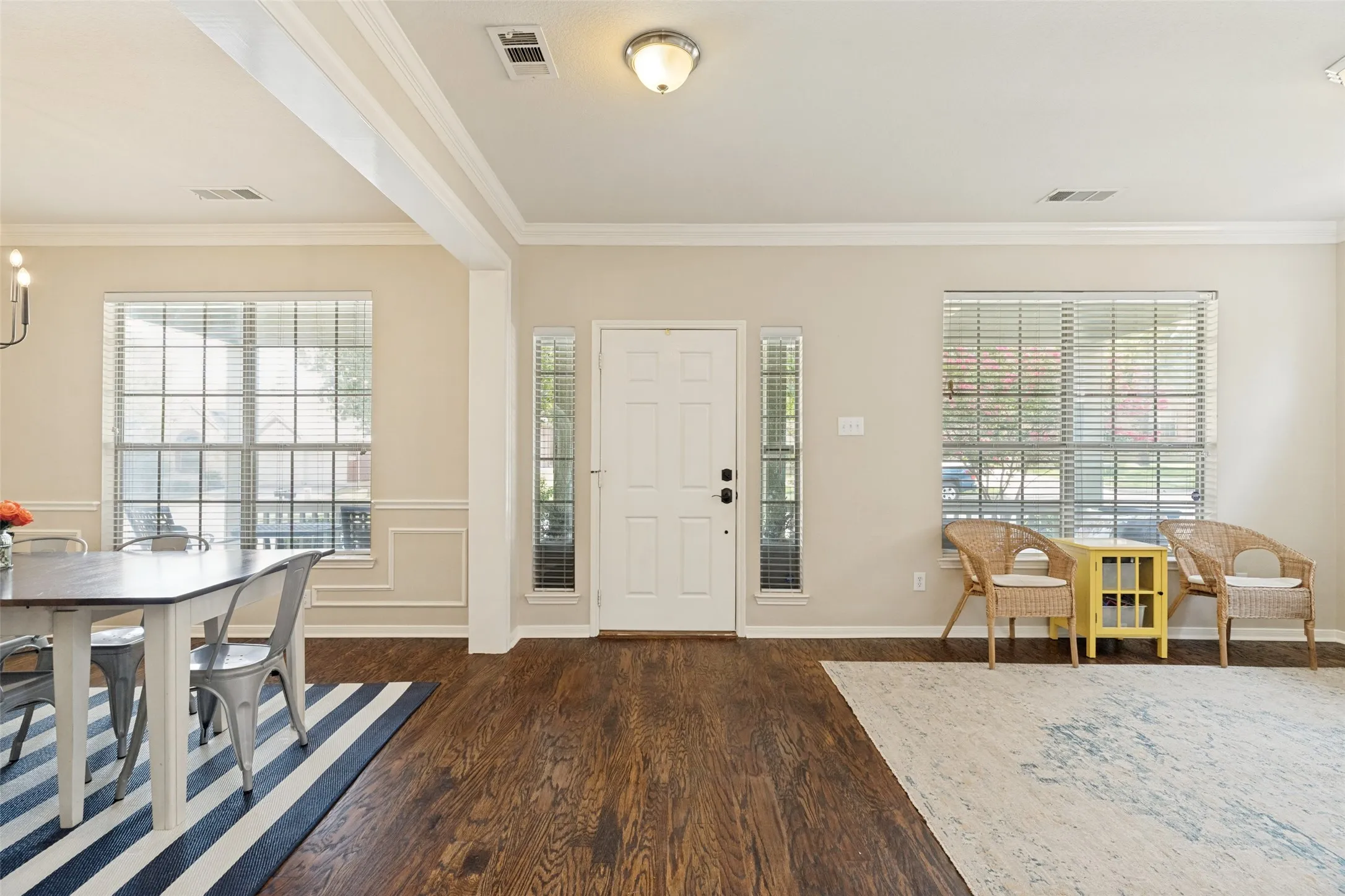 Hardwood flooring, cased openings, recessed lighting, white trim, and multiple windows