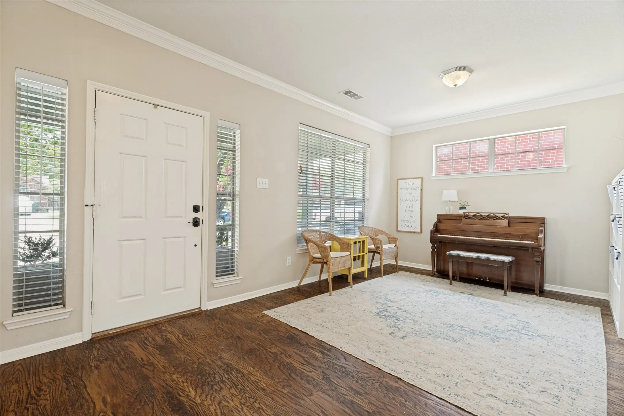 Wood-finish flooring throughout, complemented by crown molding and recessed lighting